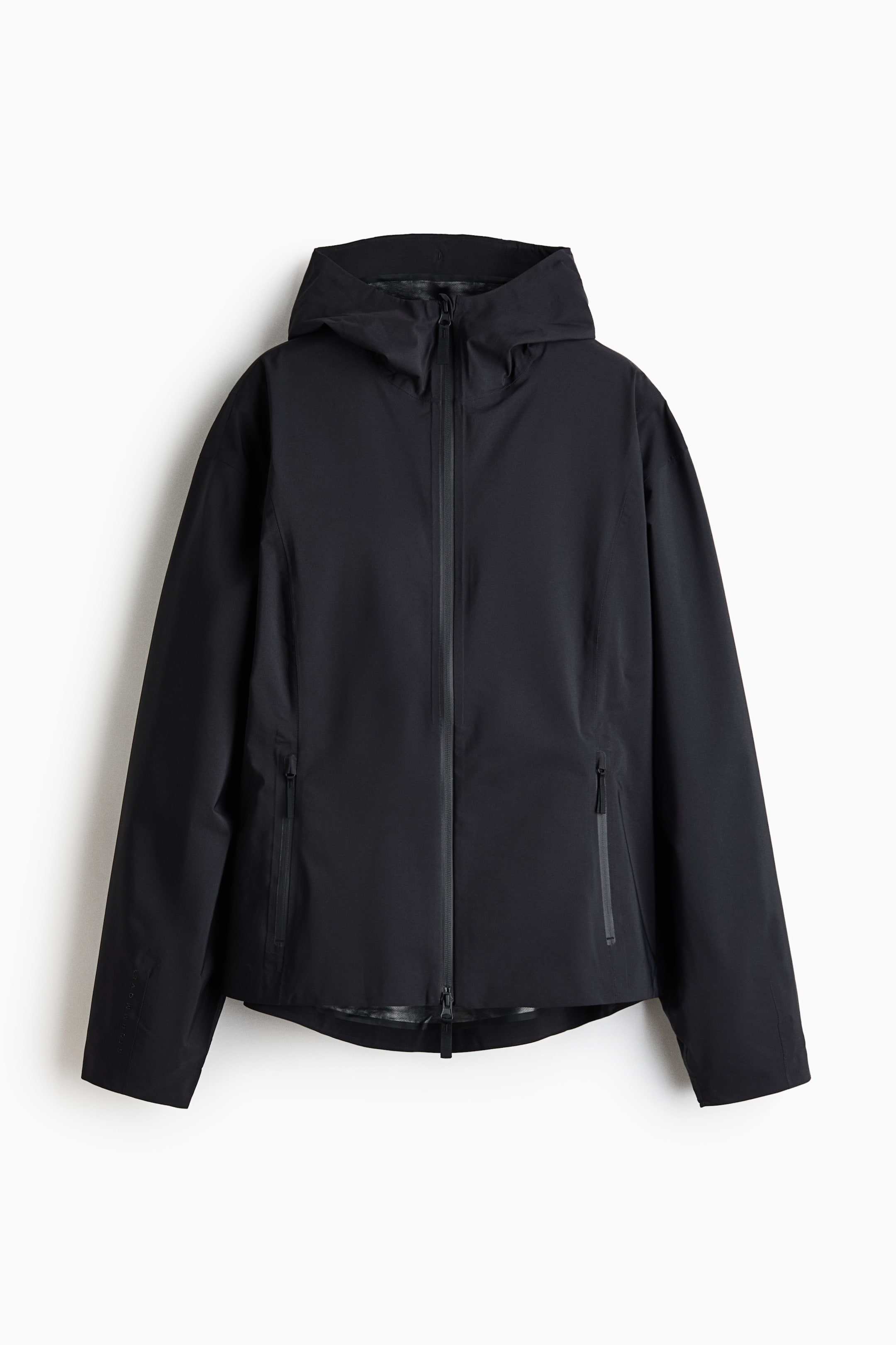 View larger image: A black hooded jacket showcasing a full-length front zipper. It features two sealed zippered pockets at the front, long sleeves, and a subtly curved hem.