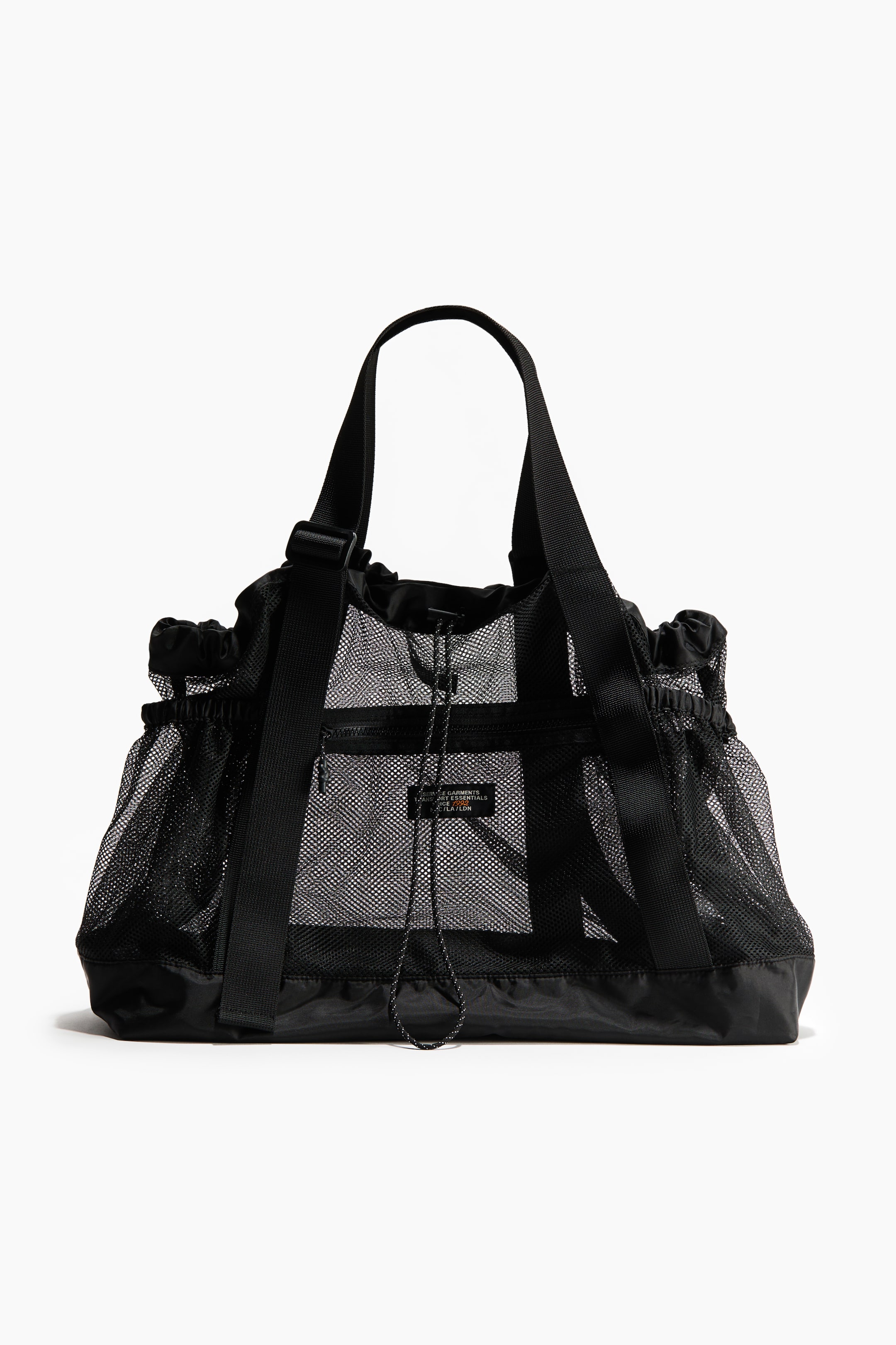 View larger image: A black tote bag in mesh is facing front. It features webbing top handles and an elasticated drawstring with cord stoppers at its top. A zipped outer pocket and side pockets with elasticated openings are visible on its exterior.