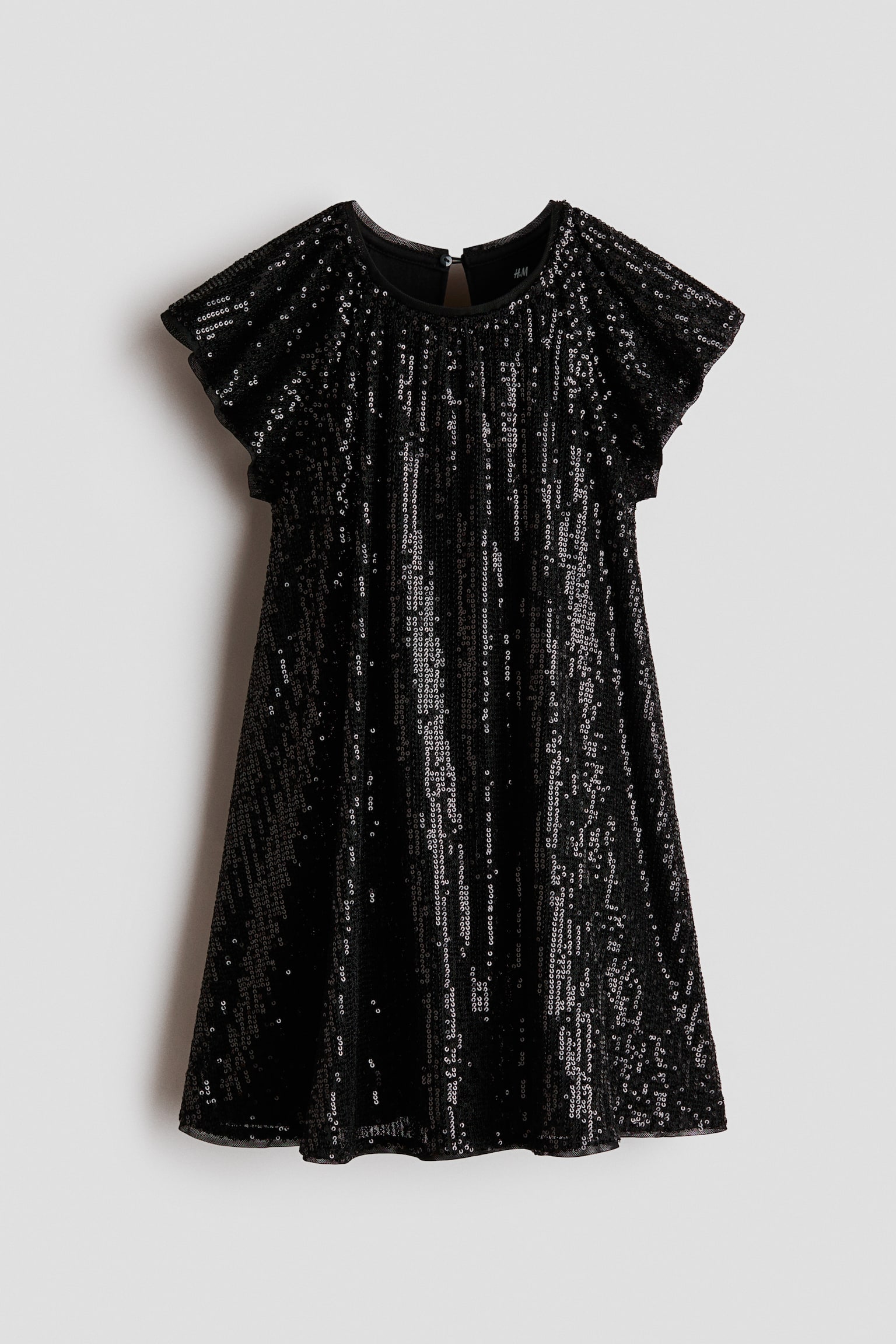 A black A-line dress is hanging facing front, featuring vertical stripes of shimmering silver and black sequins. The dress showcases a round neckline, short flutter sleeves, and a slightly flared skirt.