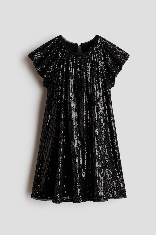 A black A-line dress is hanging front-facing, featuring vertical stripes of shimmering silver and black sequins. The dress shows a round neckline, short flutter sleeves, and a slightly flared skirt. - 1