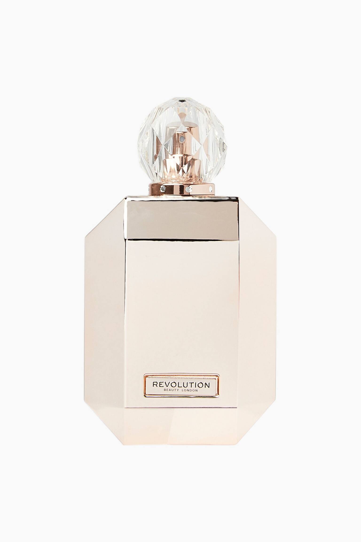 Diese ParfÃ¼mflasche steht aufrecht und zeigt eine frontale Ansicht ihres achteckigen, metallisch rosÃ©goldenen KÃ¶rpers mit einer kleinen rechteckigen Plakette nahe der Basis, auf der âREVOLUTION BEAUTY LONDONâ steht. Sie wird von einer klaren, facettierten, kristallÃ¤hnlichen Kugelkappe gekrÃ¶nt, die auf einem metallischen Kragen mit kleinen Nieten ruht. - 1
