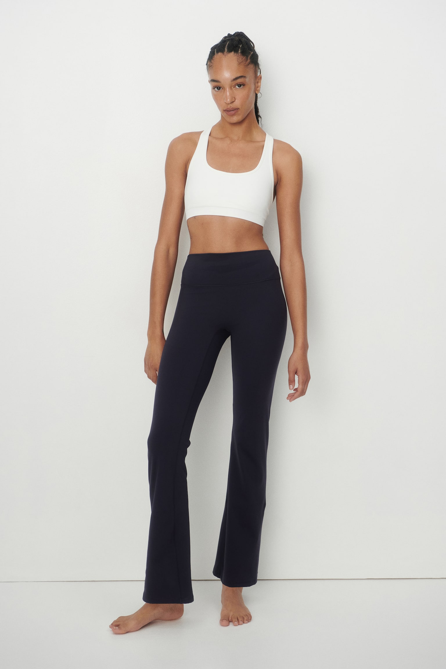Flared Yoga leggings with SoftMove? are dark navy, showcasing a high, wide waistband and a sleek, flared leg design. They are displayed flat, facing forward. - 1