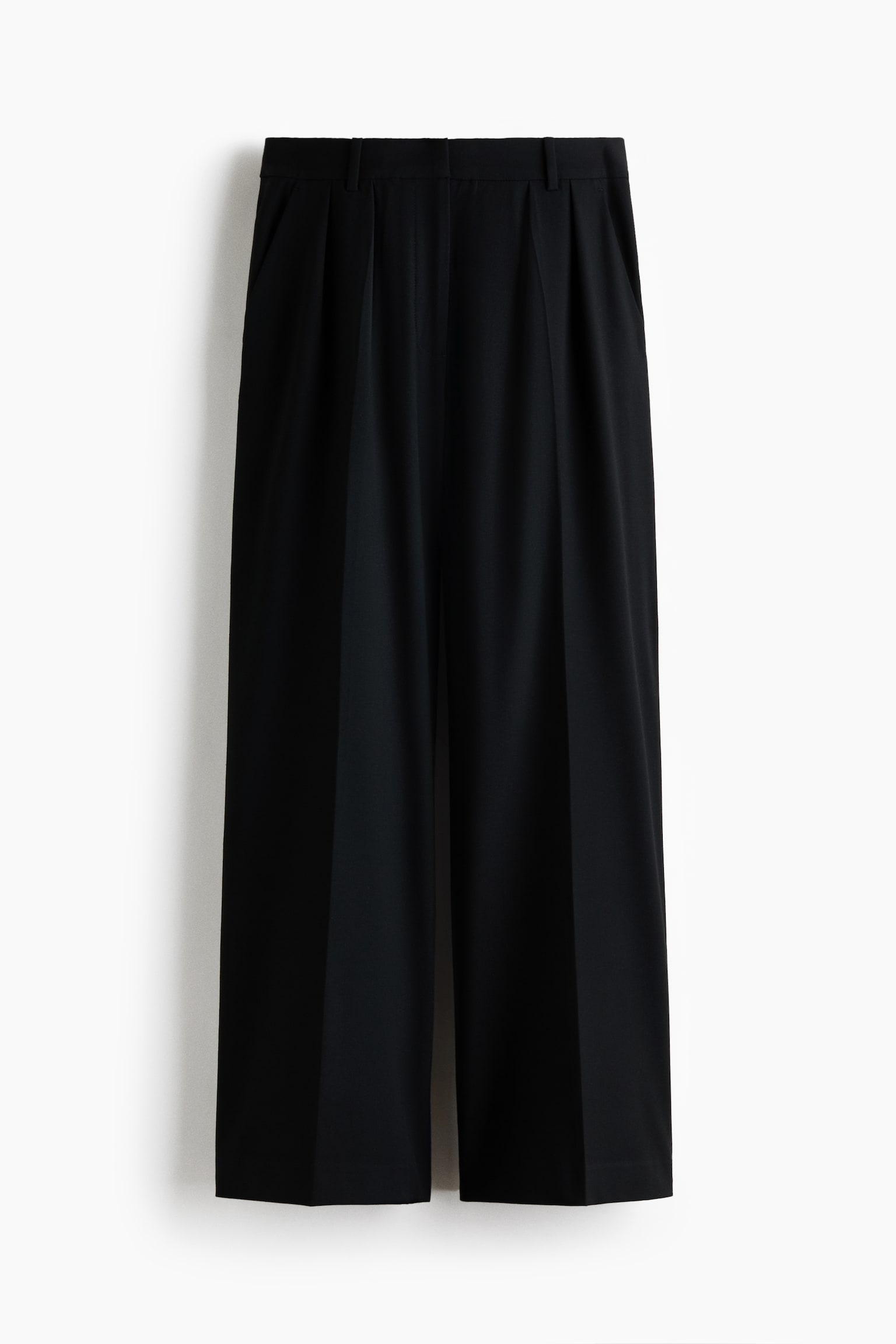 Black wide-leg trousers are hanging facing the front, featuring a structured waistband with belt loops and front pleats. The trousers are displaying sharp pressed creases running down the center of each wide leg.