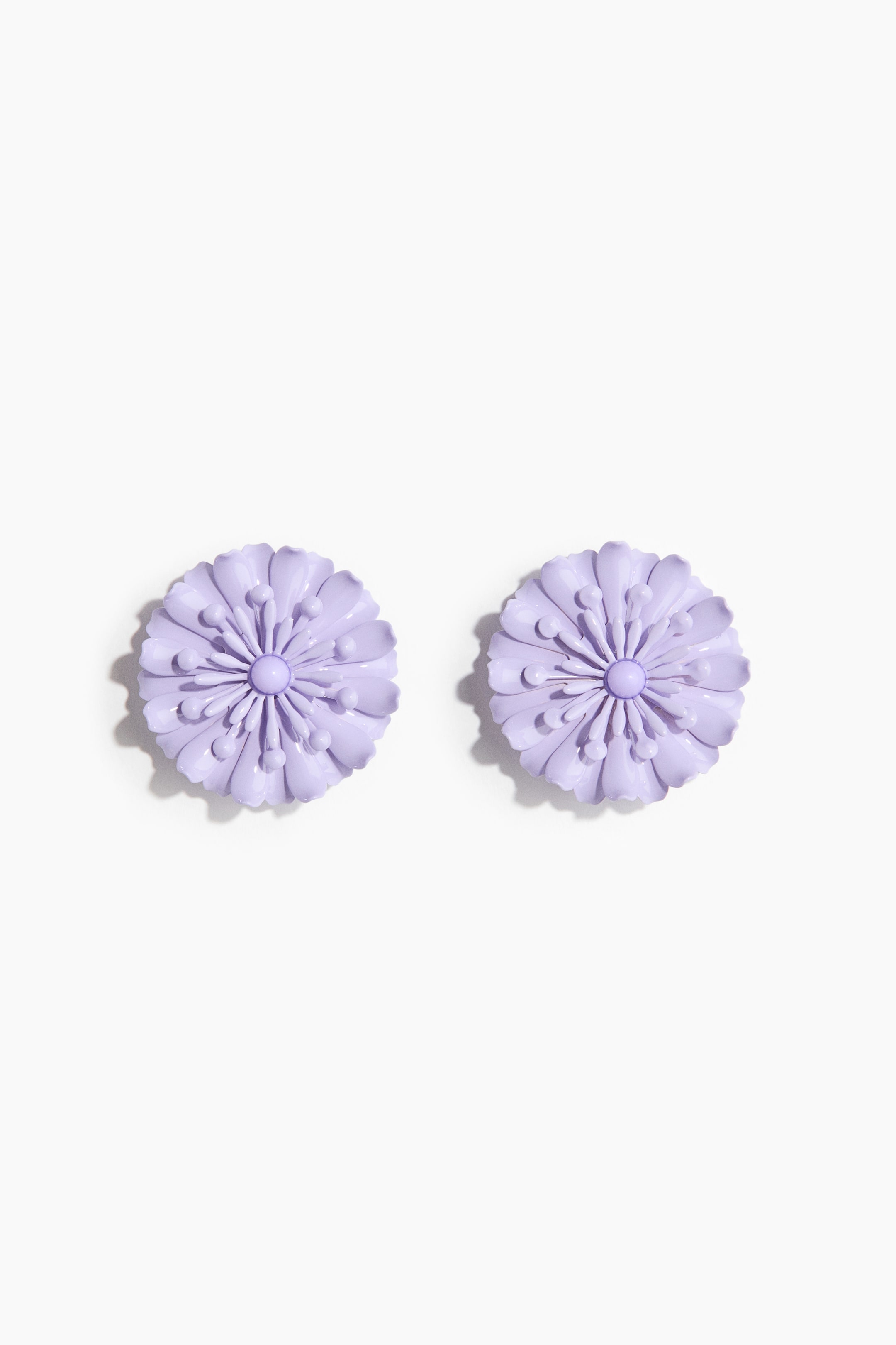View larger image: Flower-shaped metal earrings exhibit a light purple, glossy finish when viewed from the front. Each earring showcases a central domed button, radiating petal-like forms, and small raised spherical details.