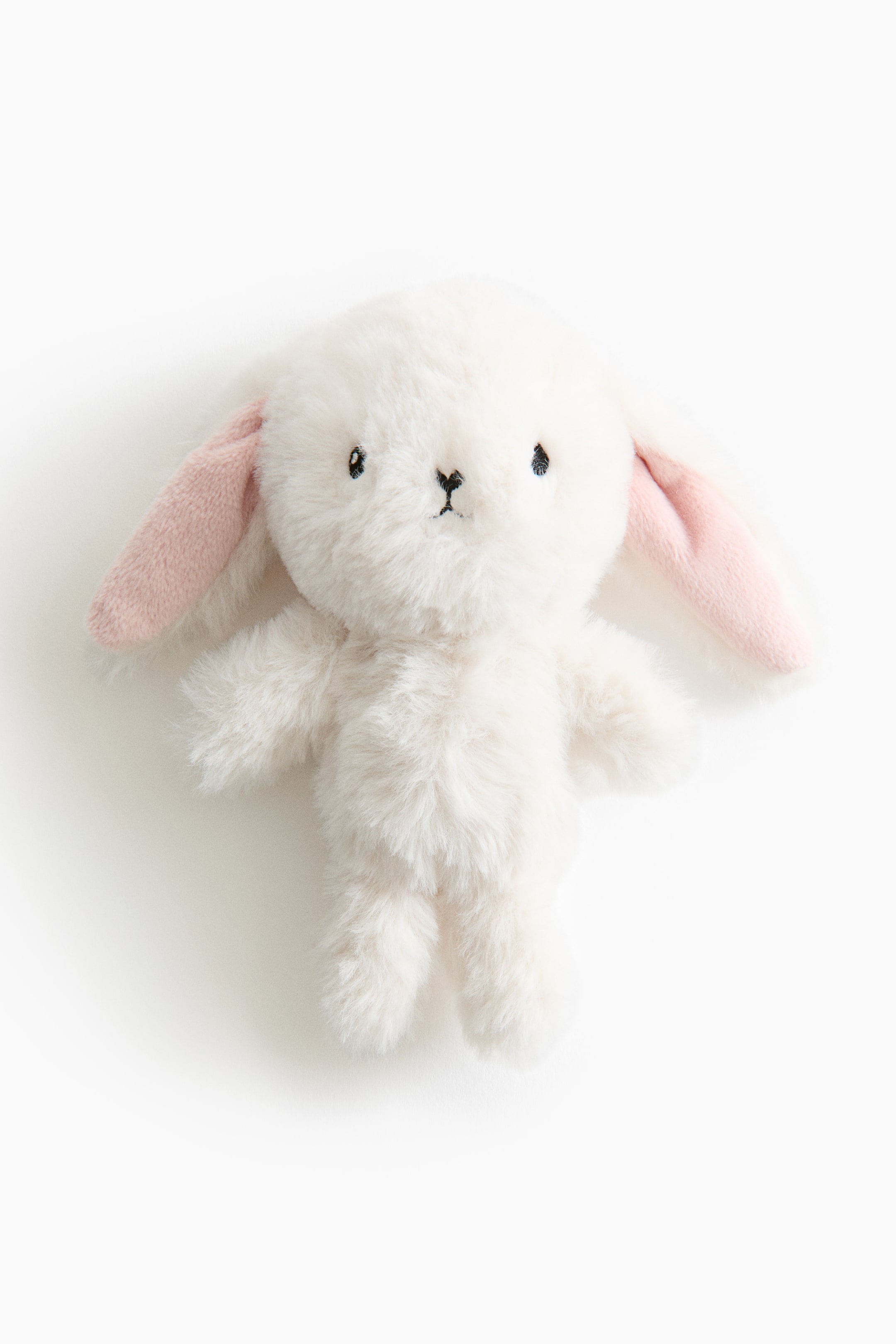 View larger image: A plush baby rattle shaped like a white bunny, crafted from soft pile fabric, is facing forward, showcasing pink inner ears and embroidered black eyes and nose.