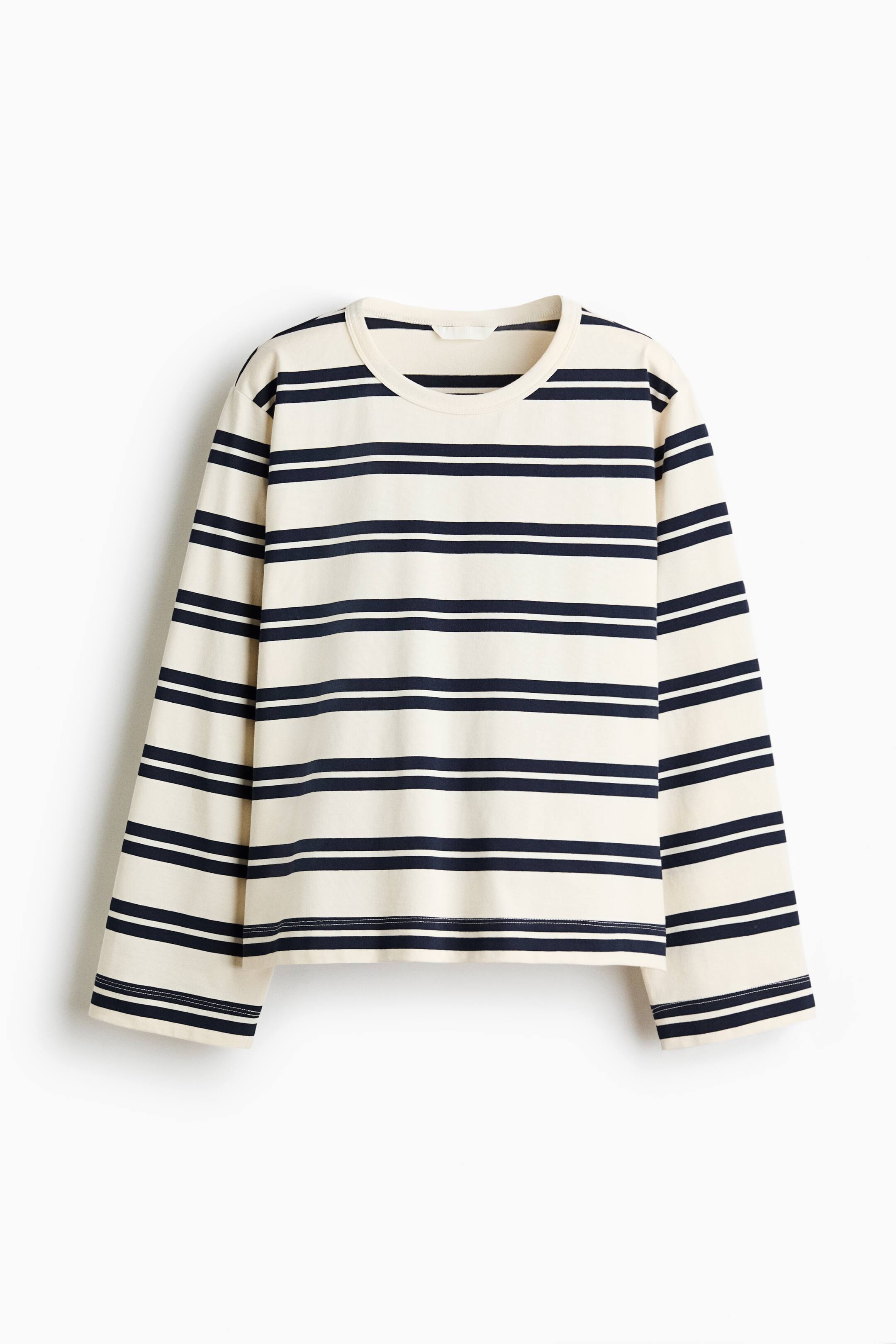 View larger image: A cream-coloured long-sleeved shirt is facing FRONT, displaying horizontal navy-blue stripes of varying widths, a round neckline, and long sleeves.