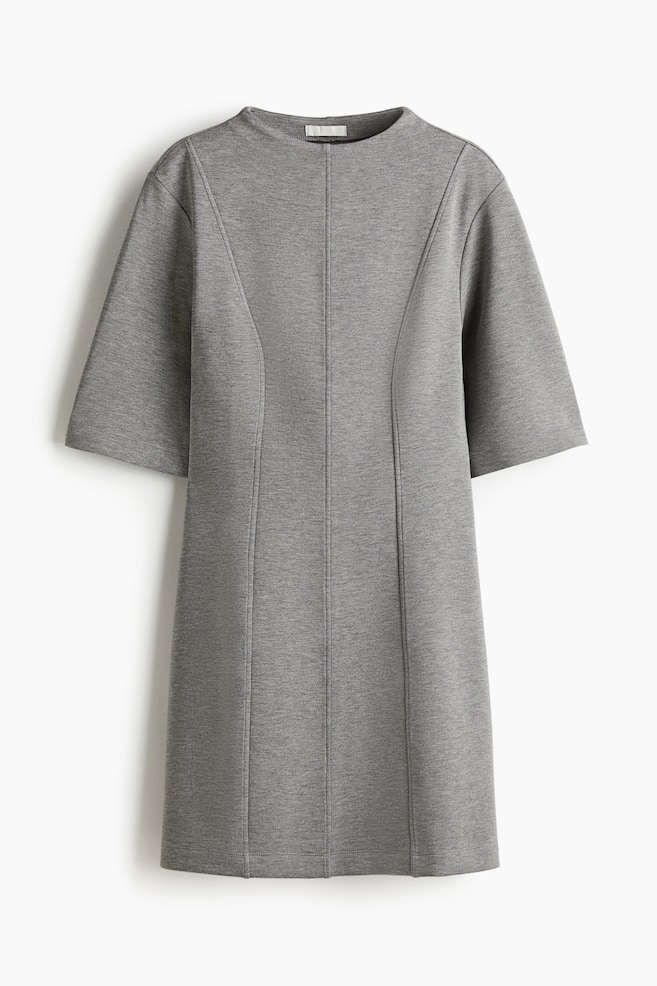 A heather gray knit dress is presented front-facing, featuring a round neckline and short, wide sleeves. It is detailed with a central front seam and two curved vertical seams extending from the shoulders, shaping the silhouette. - 1