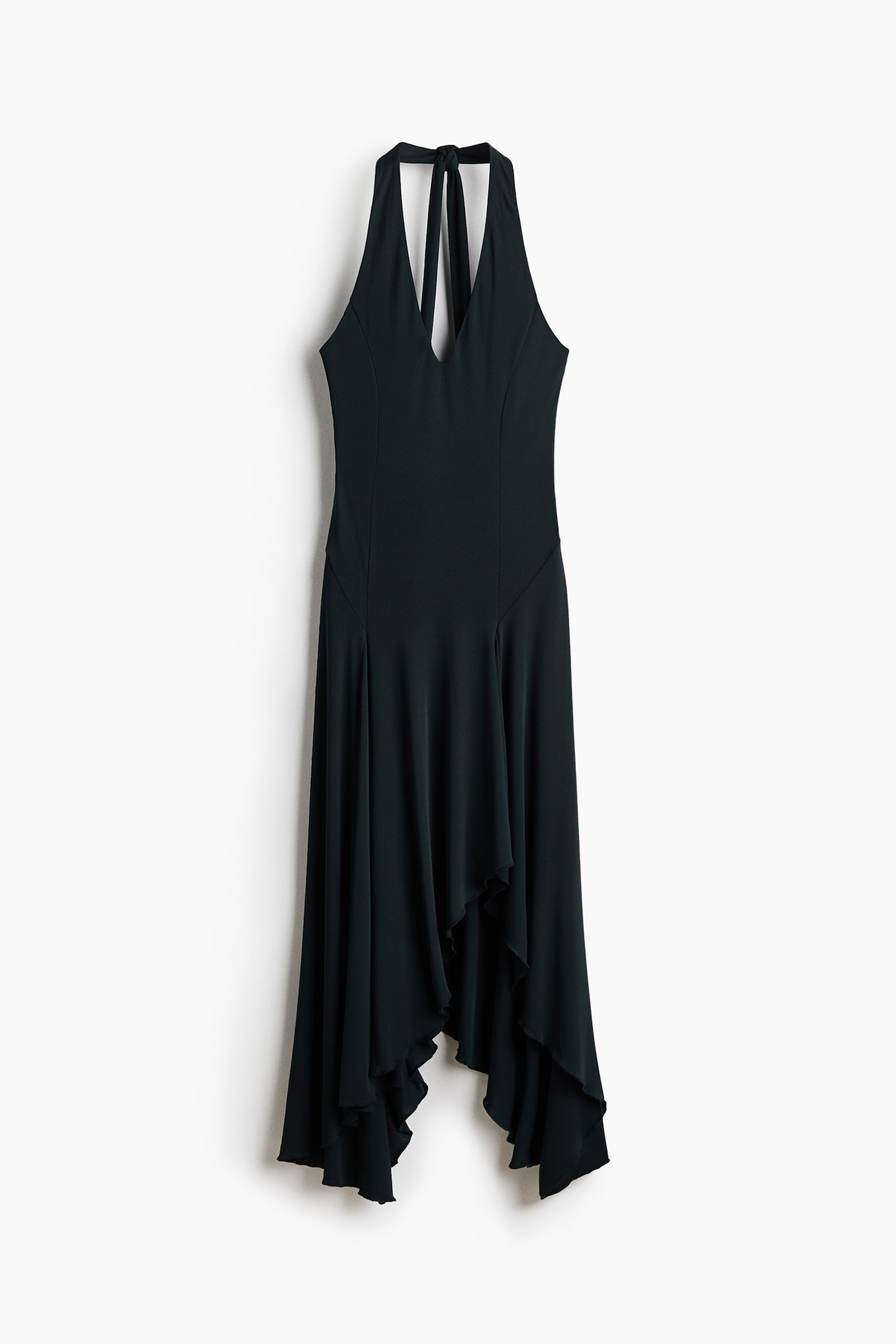 A dark green halter dress is shown from the front, featuring a fitted bodice with a deep V-neckline and a self-tie halterneck. The skirt drapes down into an asymmetric, handkerchief-style hemline with fluid folds.