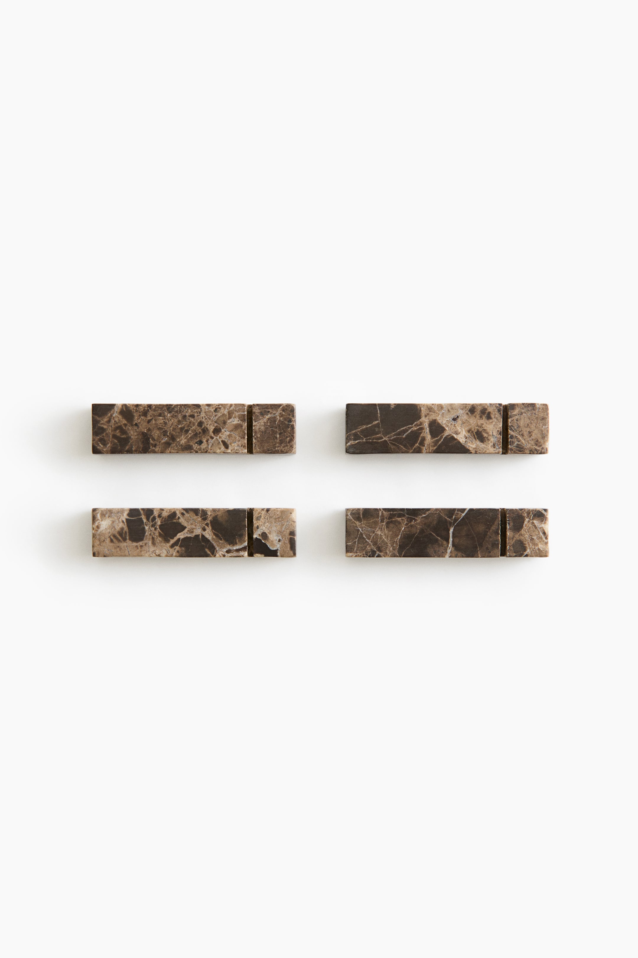 View larger image: Four rectangular marble blocks are facing the front, arranged in a two-by-two grid. Each block features a brown and tan veined pattern, with a narrow vertical groove carved near one end.
