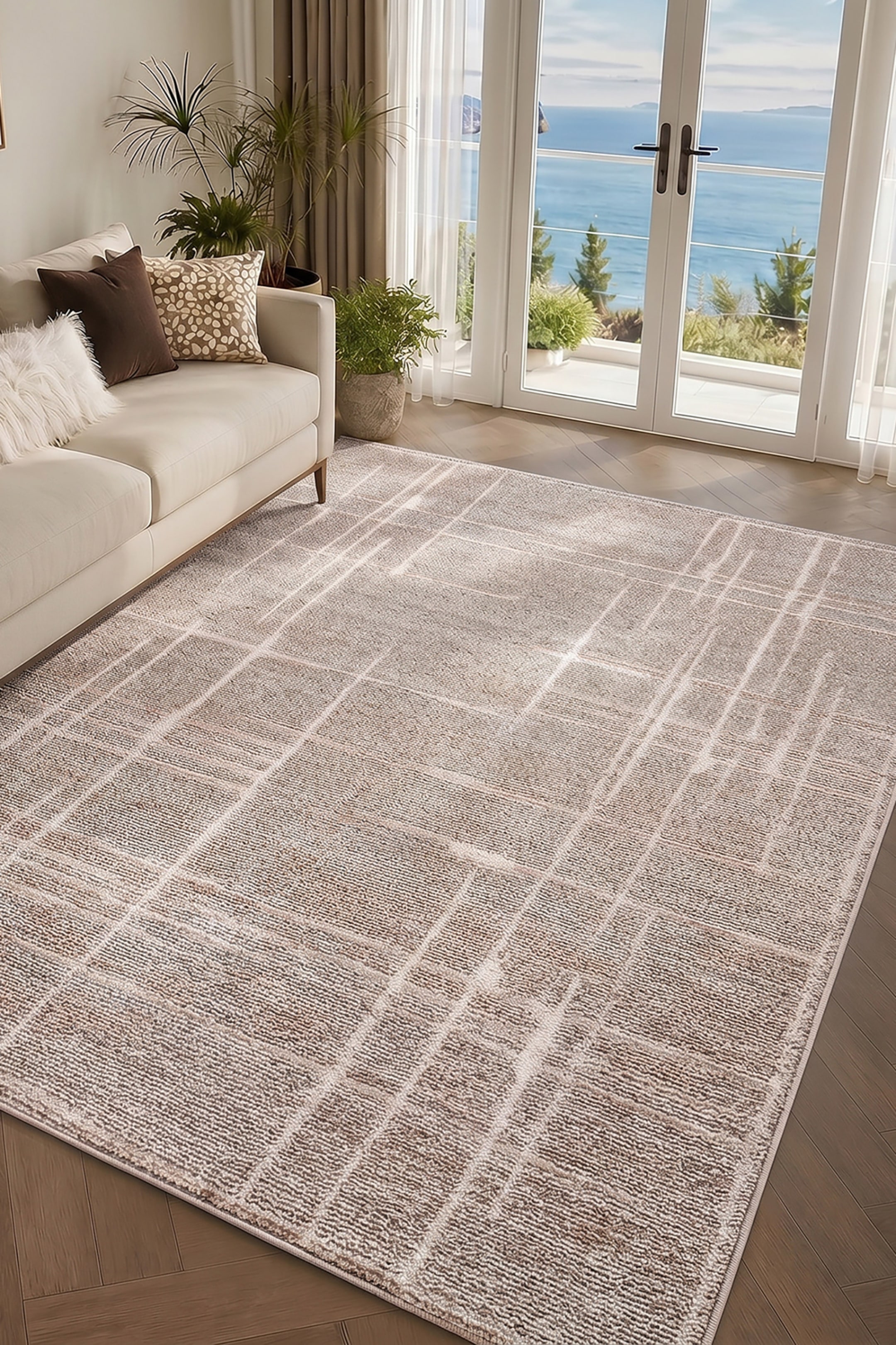 View larger image: A rectangular area rug is showcasing a textured, multi-tonal beige and cream surface decorated with an abstract grid pattern of intersecting white lines. The low-pile rug is exhibiting a finely ribbed woven texture that gives it a structured, modern appearance.