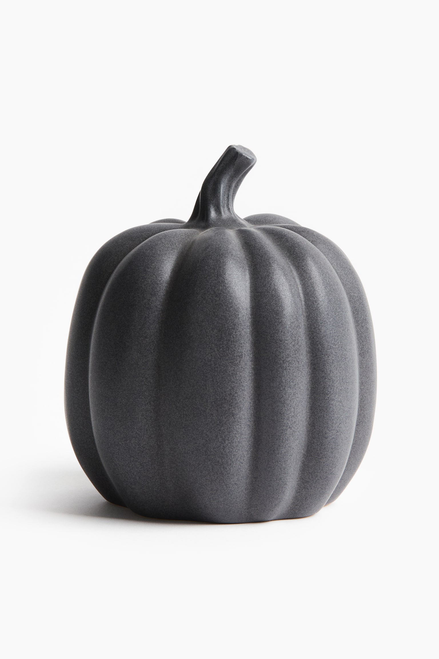 A dark grey decorative pumpkin faces forward and slightly to the right, showcasing a textured surface with prominent vertical ridges. A short, curved stem emerges from its top. - 1