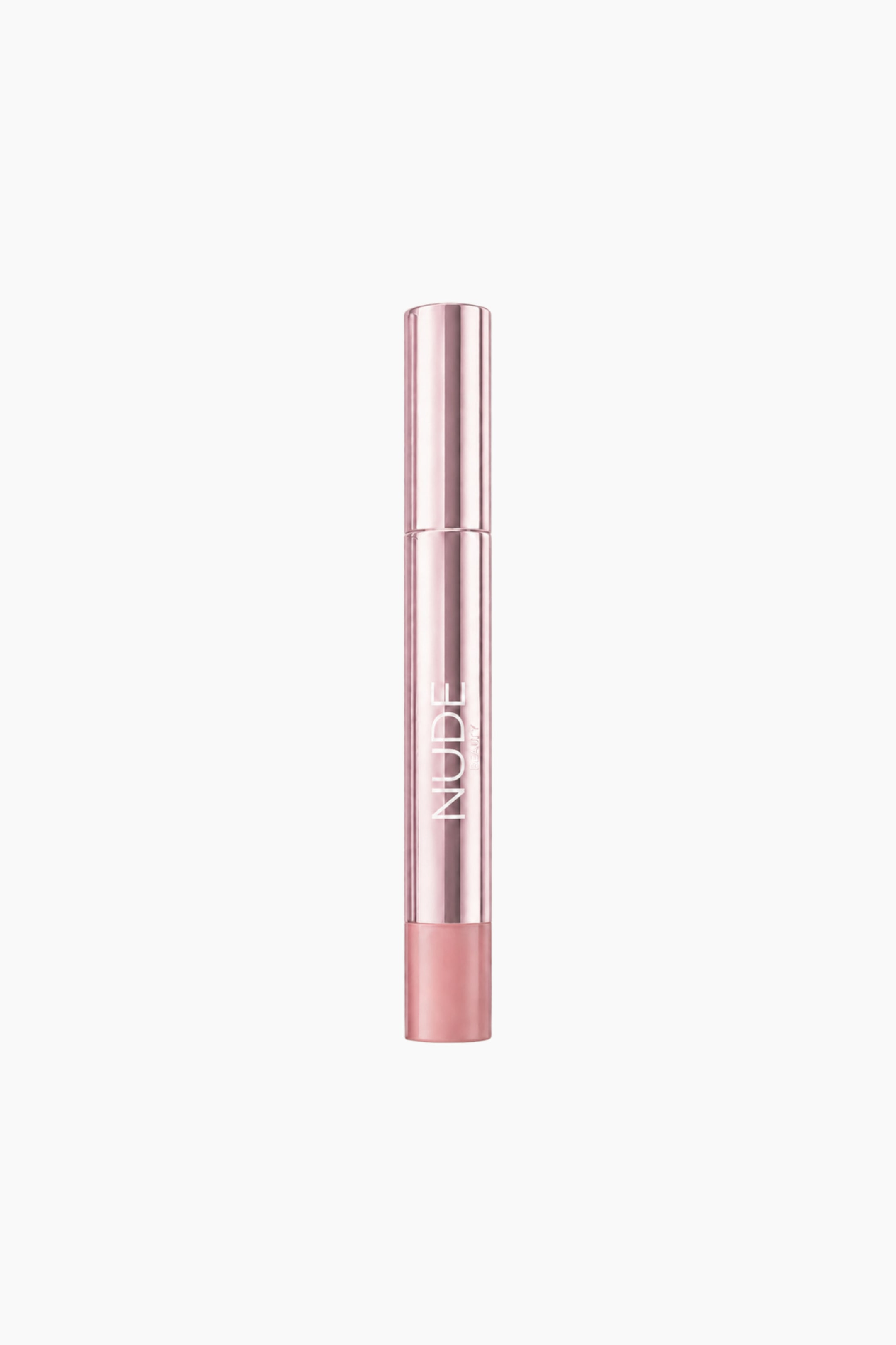Vis større bilde: Et sylindrisk leppeprodukt-rør i roségull står oppreist, med «NUDE» skrevet vertikalt på siden. Et lyserosa leppeprodukt er synlig og stikker ut fra bunnen av røret.