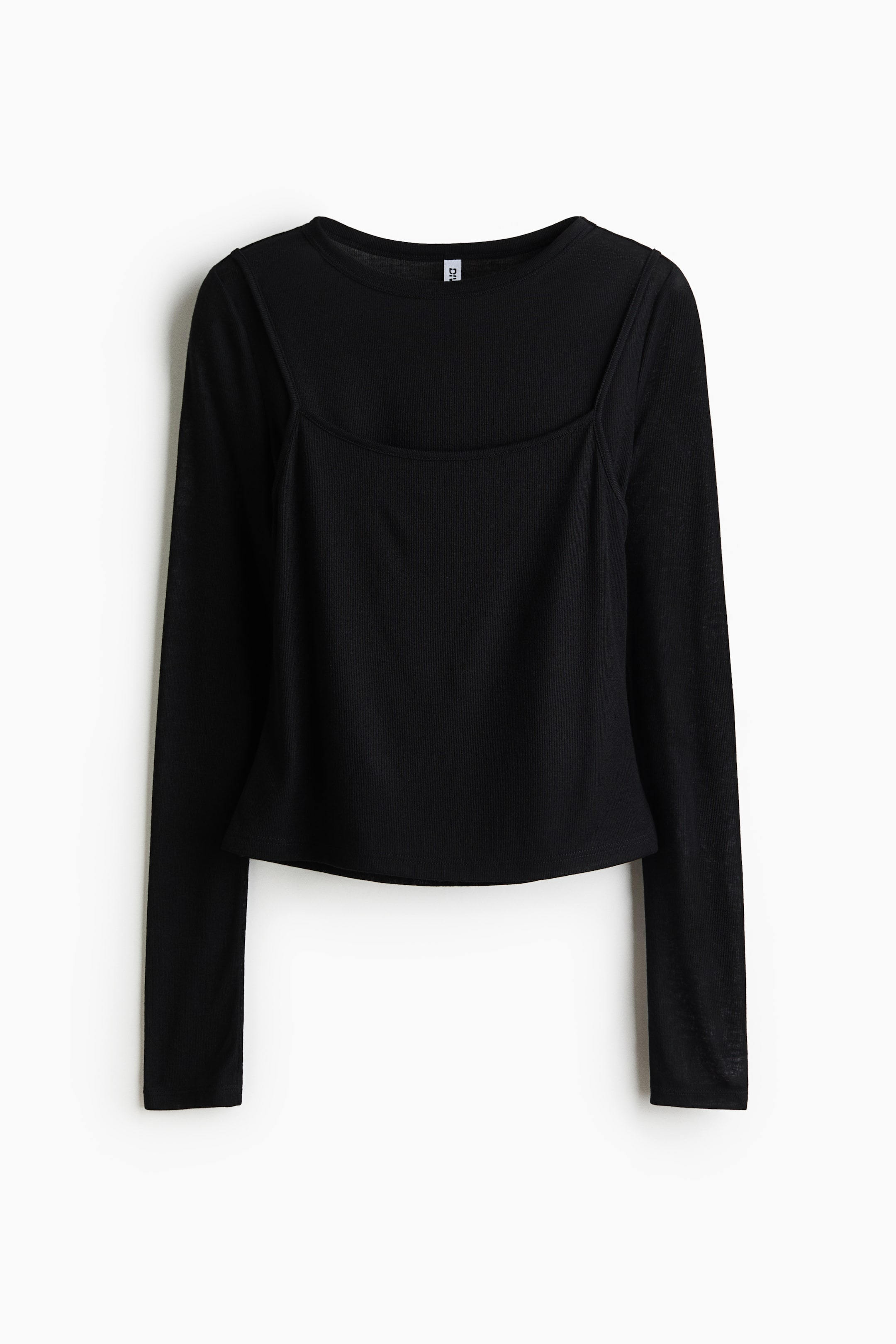 View larger image: A black layered top features a long-sleeve underlayer with a round neckline and sheer sleeves, layered with a square-neck ribbed overlay with thin straps. The top has a cropped length.