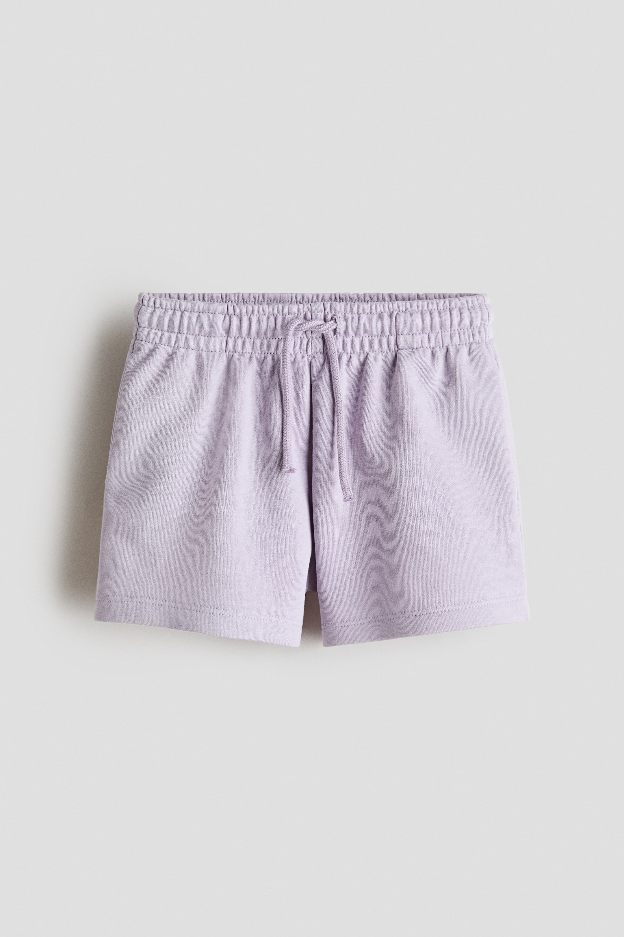 View larger image: Light purple shorts feature an elastic, drawstring waist with the drawstring tied in a bow, crafted from a lightweight sweatshirt fabric, shown from the front.