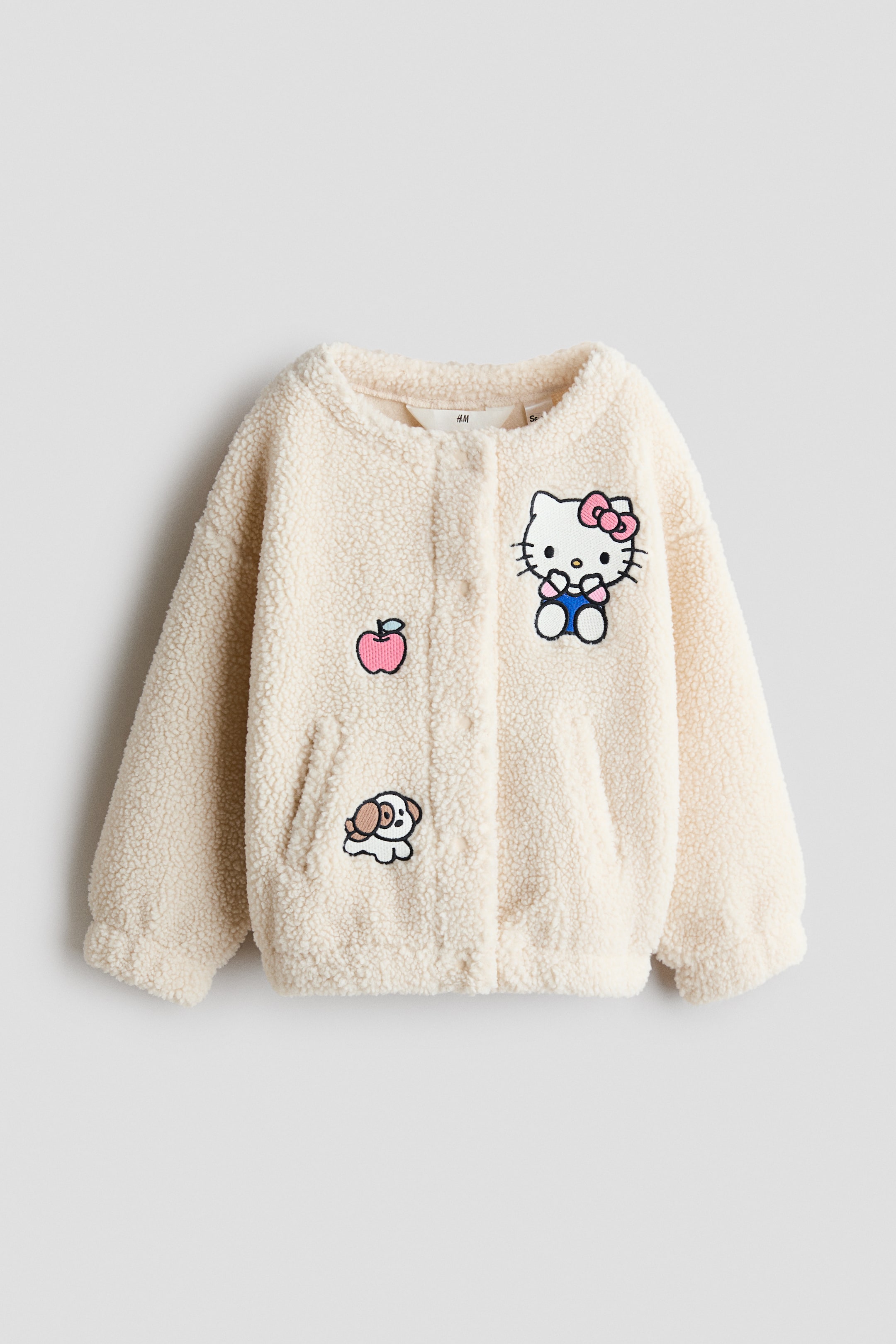 הצגת תמונה גדולה יותר: Patch-detail teddy jacket - בז' בהיר/הלו קיטי - Kids | H&M IL 1
