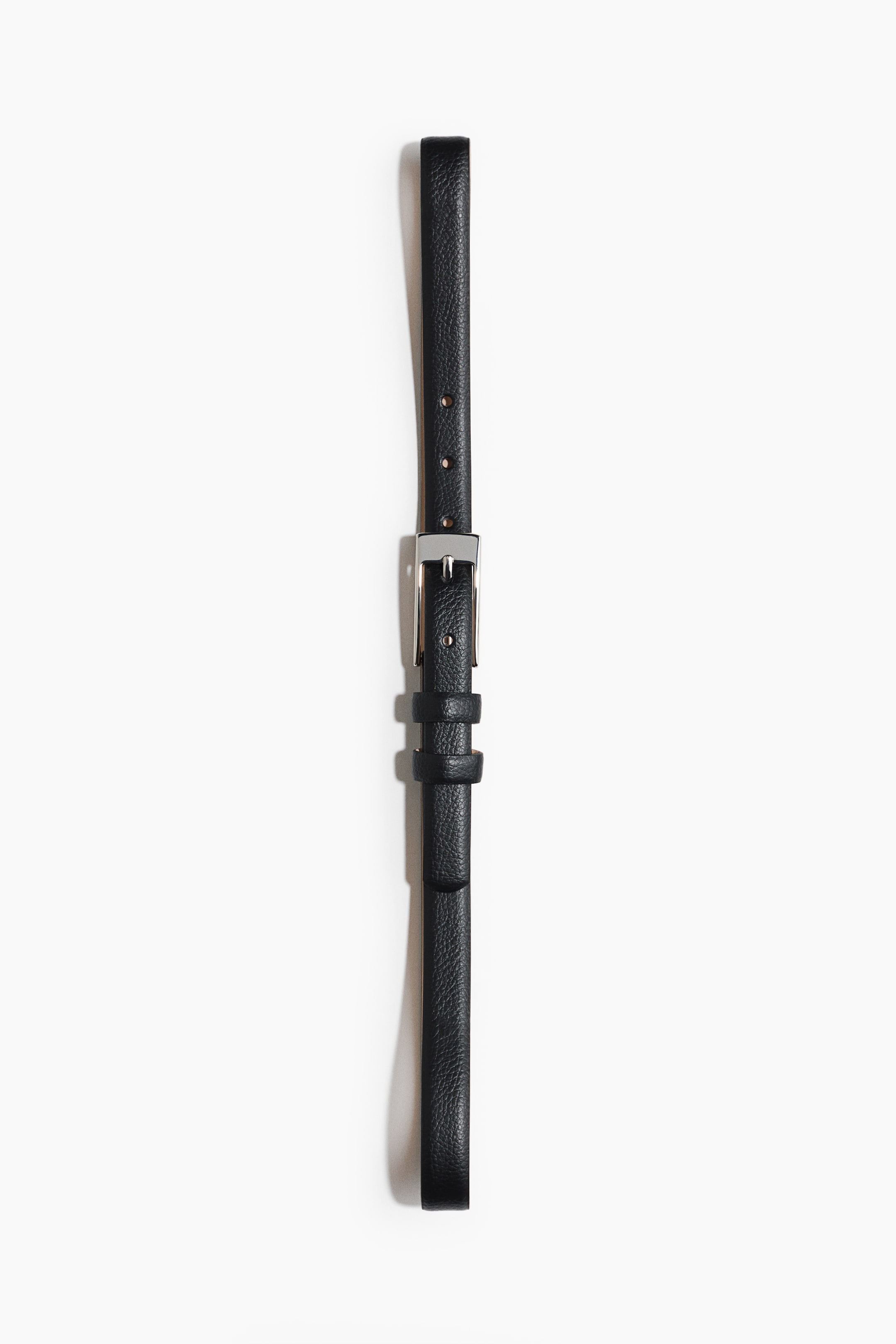 View larger image: A black leather belt is positioned vertically, showcasing a silver-toned rectangular pin buckle and two strap keepers. It features a pebbled texture and multiple adjustment holes along its narrow strap.