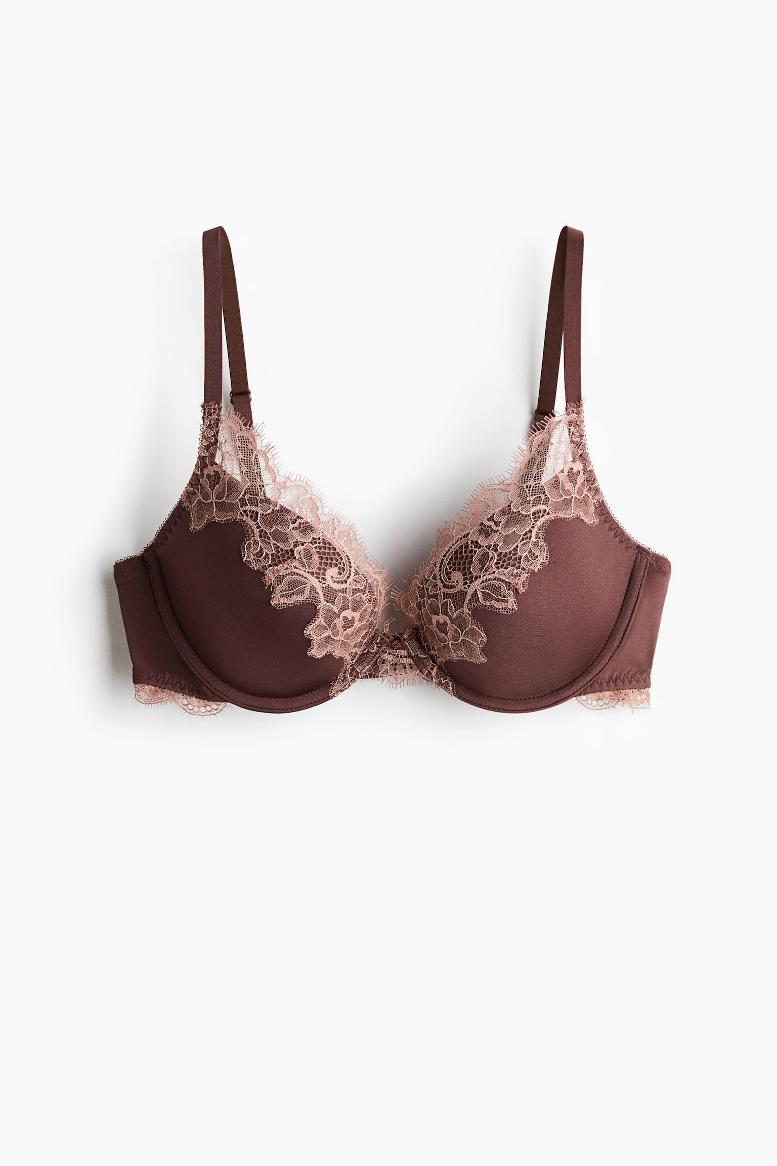 A front-facing bra featuring smooth, dark brown padded cups, intricately adorned with blush pink floral lace along the upper edges and centre gore. A delicate strip of matching scalloped lace details the underband. - 1