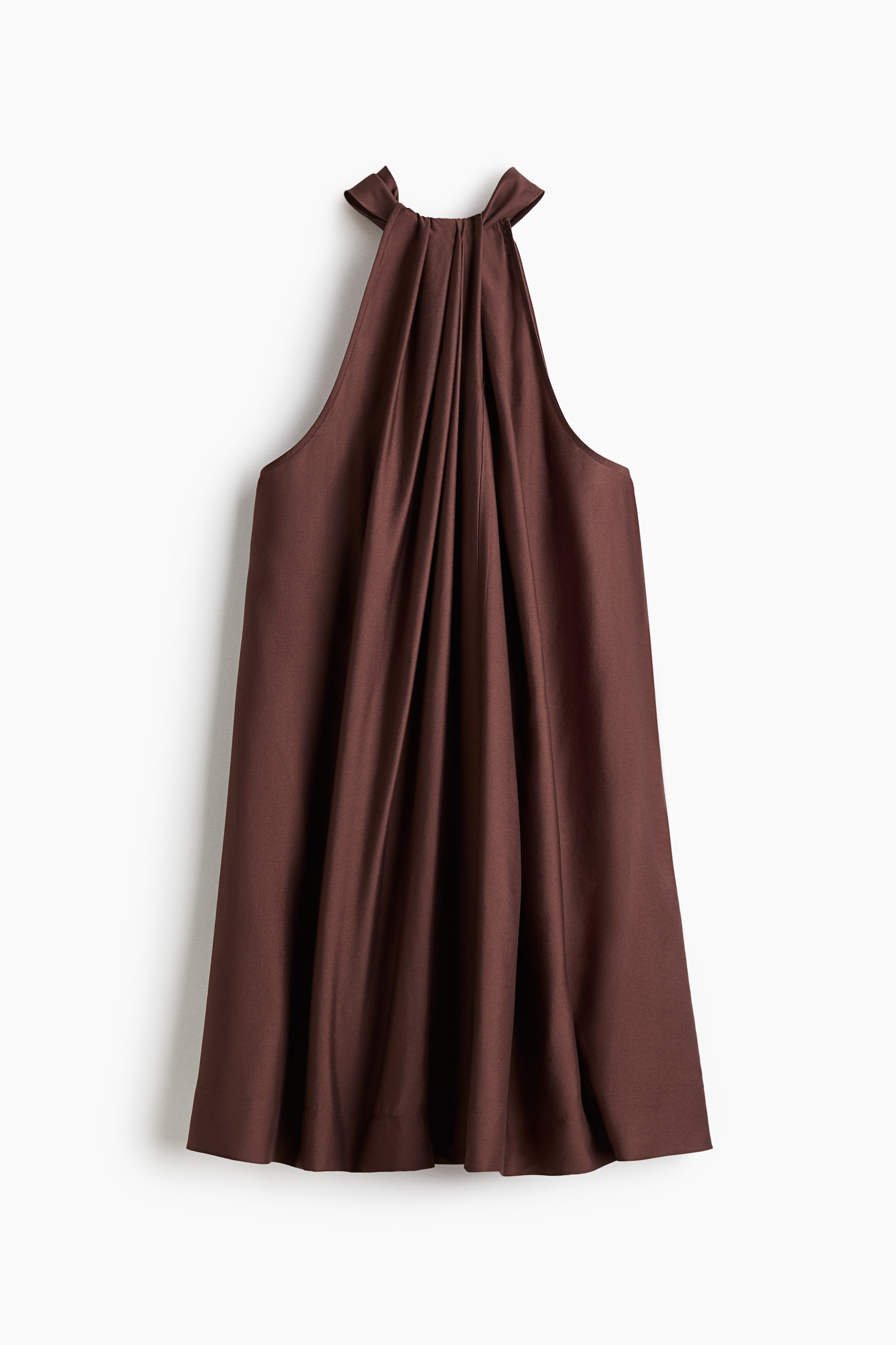 View larger image: A dark brown halter top is shown from the front. It is featuring a high neckline that is gathering into prominent vertical pleats, which are draping softly down the front of the garment.