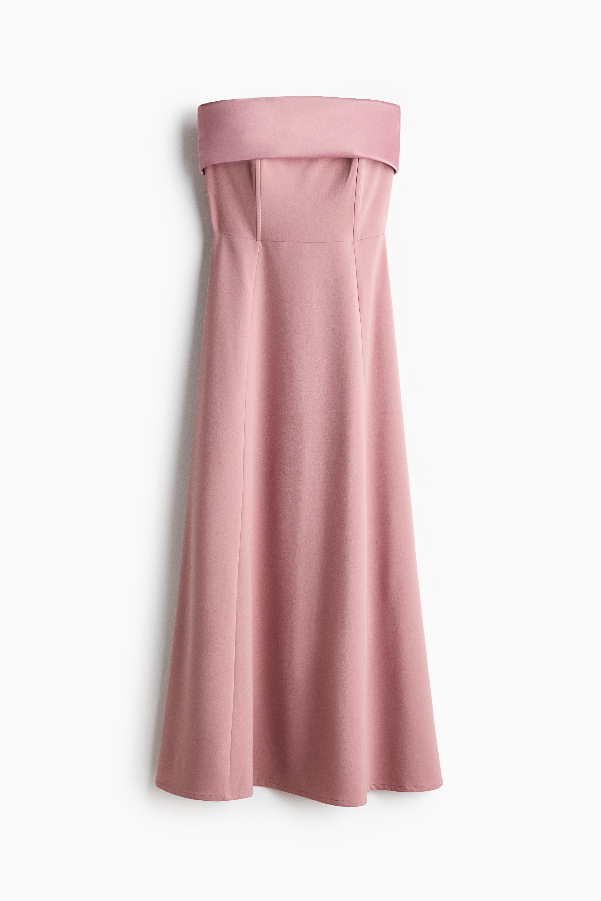 A pink bandeau dress featuring a satin foldover top edge and a fitted bodice with vertical structural seams is being worn by the model. The look is styled with black rectangular sunglasses and a long, dangling gold-toned earring.