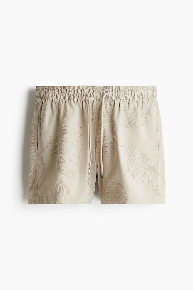 Gemusterte Badeshorts - Beige/Blattmuster/Schwarz/Blattmuster - 1