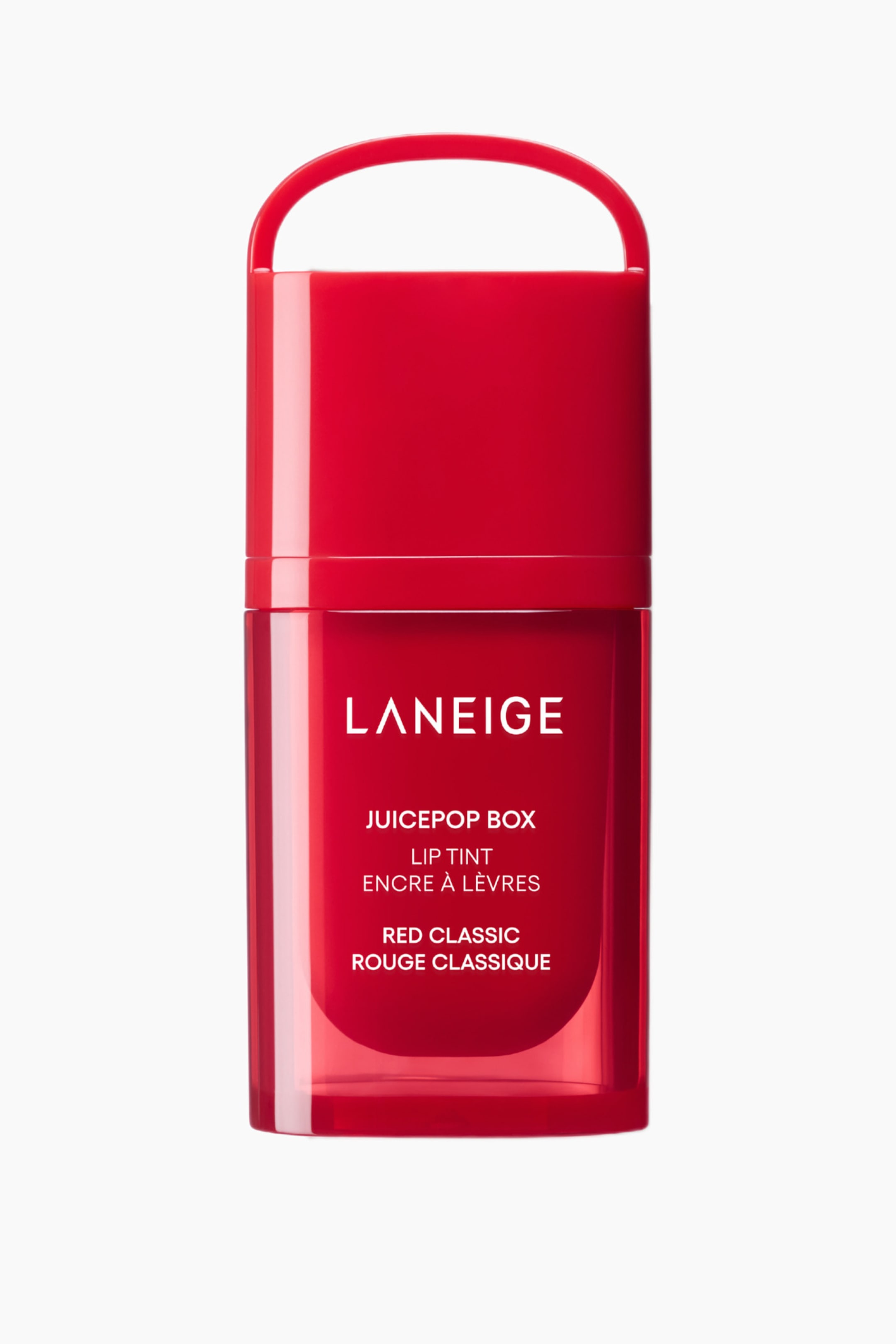 Visa större bild: En röd Laneige Juicepop Box Lip Tint står upprätt och vänd framåt, med en ogenomskinlig röd kork med ett integrerat topphandtag och en genomskinlig röd kropp. Vit text märker produkten som 'LANEIGE JUICEPOP BOX LIP TINT RED CLASSIC' på engelska och franska på framsidan av kroppen.