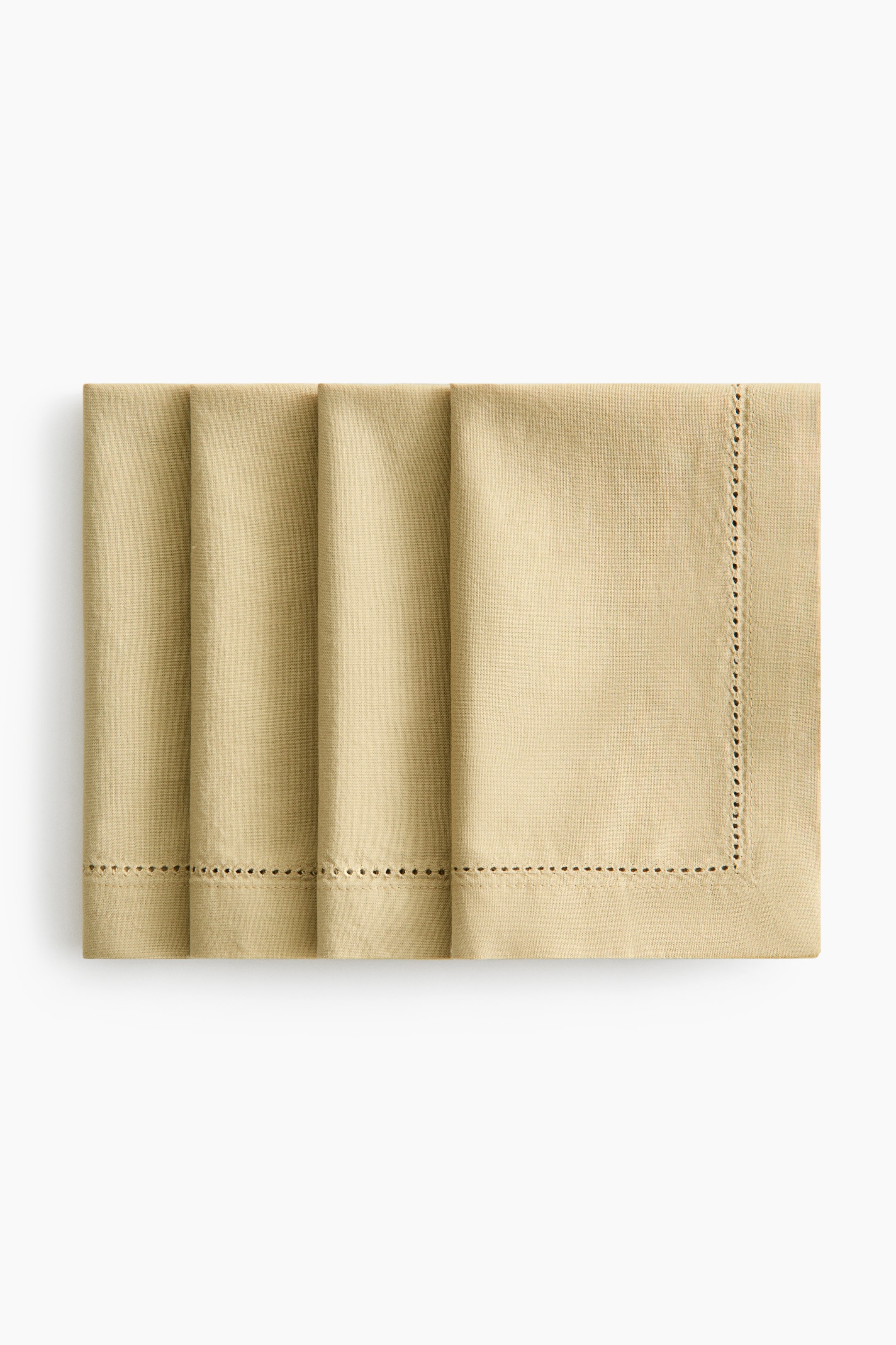View larger image: Four light tan cotton canvas napkins are displayed, neatly folded and stacked horizontally. Each napkin showcases intricate hemstitch detailing along the visible edges, creating a refined 2.5 cm hem.