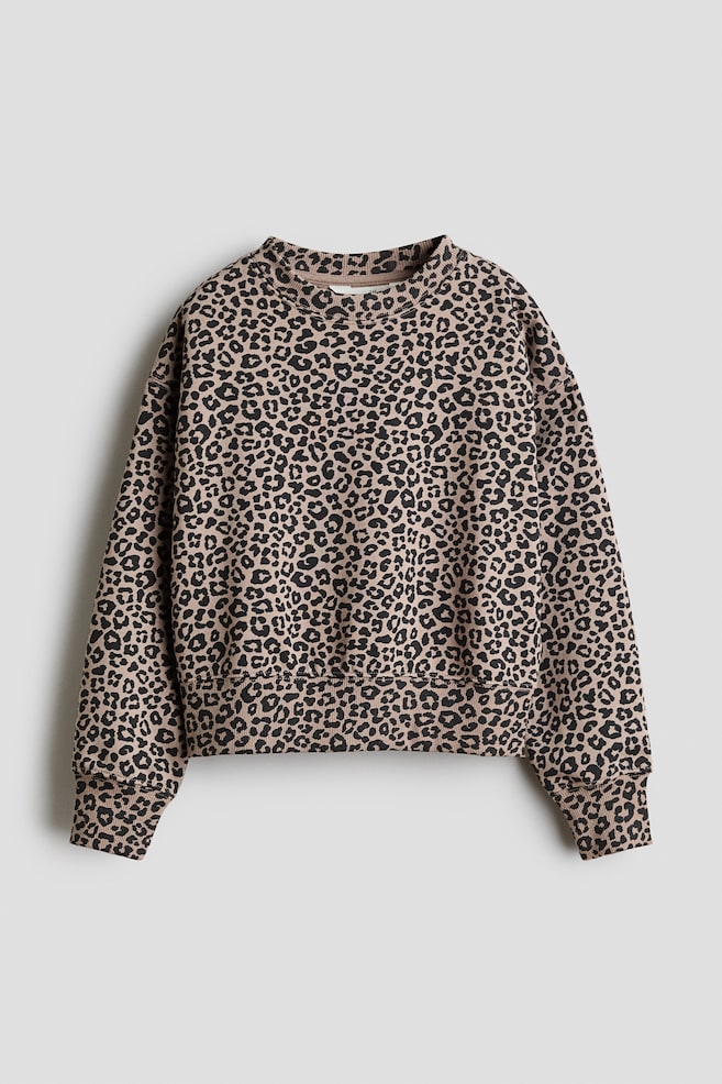 A loose-fit leopard-print sweater is shown from the front, featuring a round rib-trimmed neckline, dropped shoulders, and wide ribbed trims at the cuffs and hem. - 1