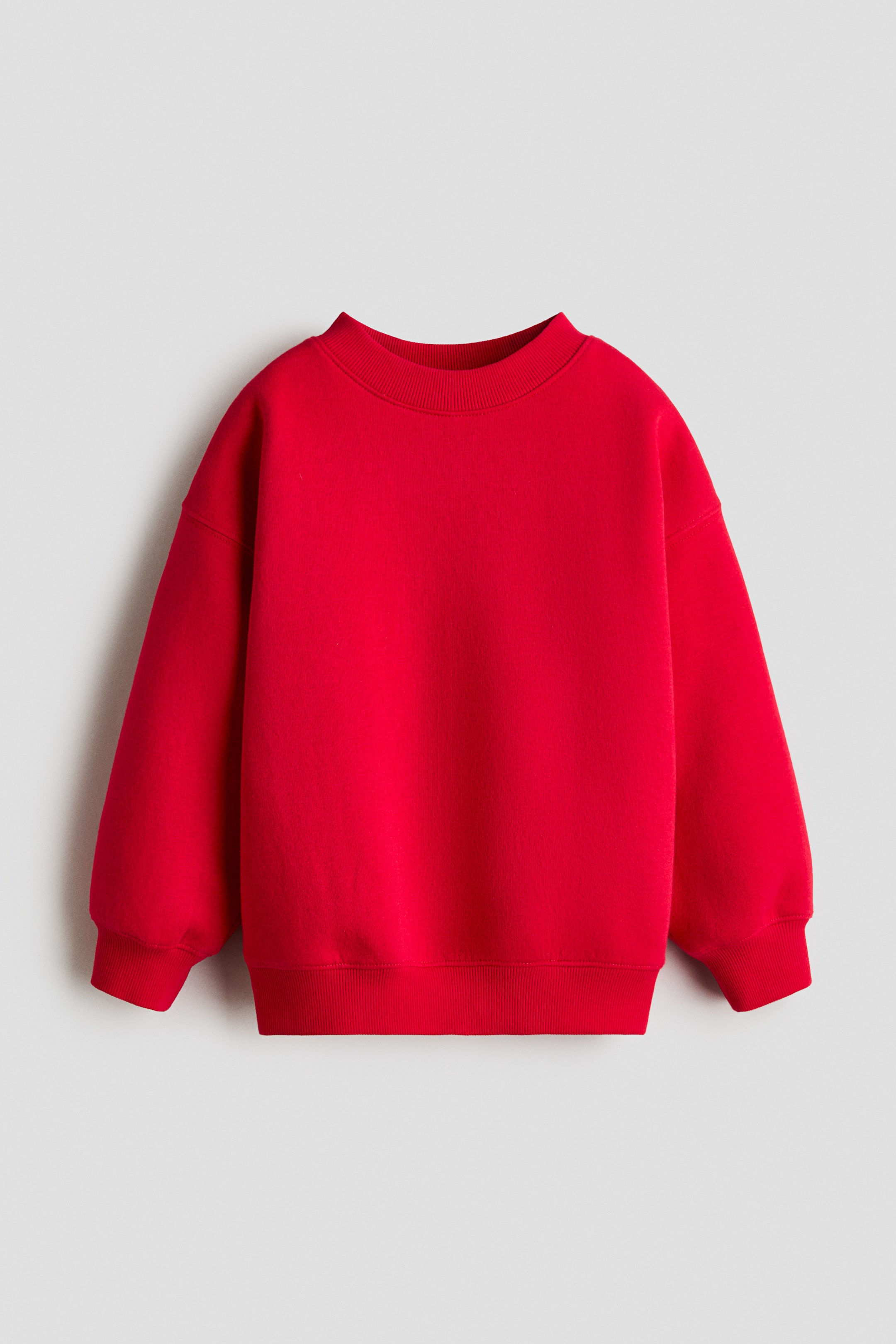 View larger image: A red sweatshirt is facing front. It features a ribbed crew neck, long relaxed sleeves with ribbed cuffs, and a ribbed hem.