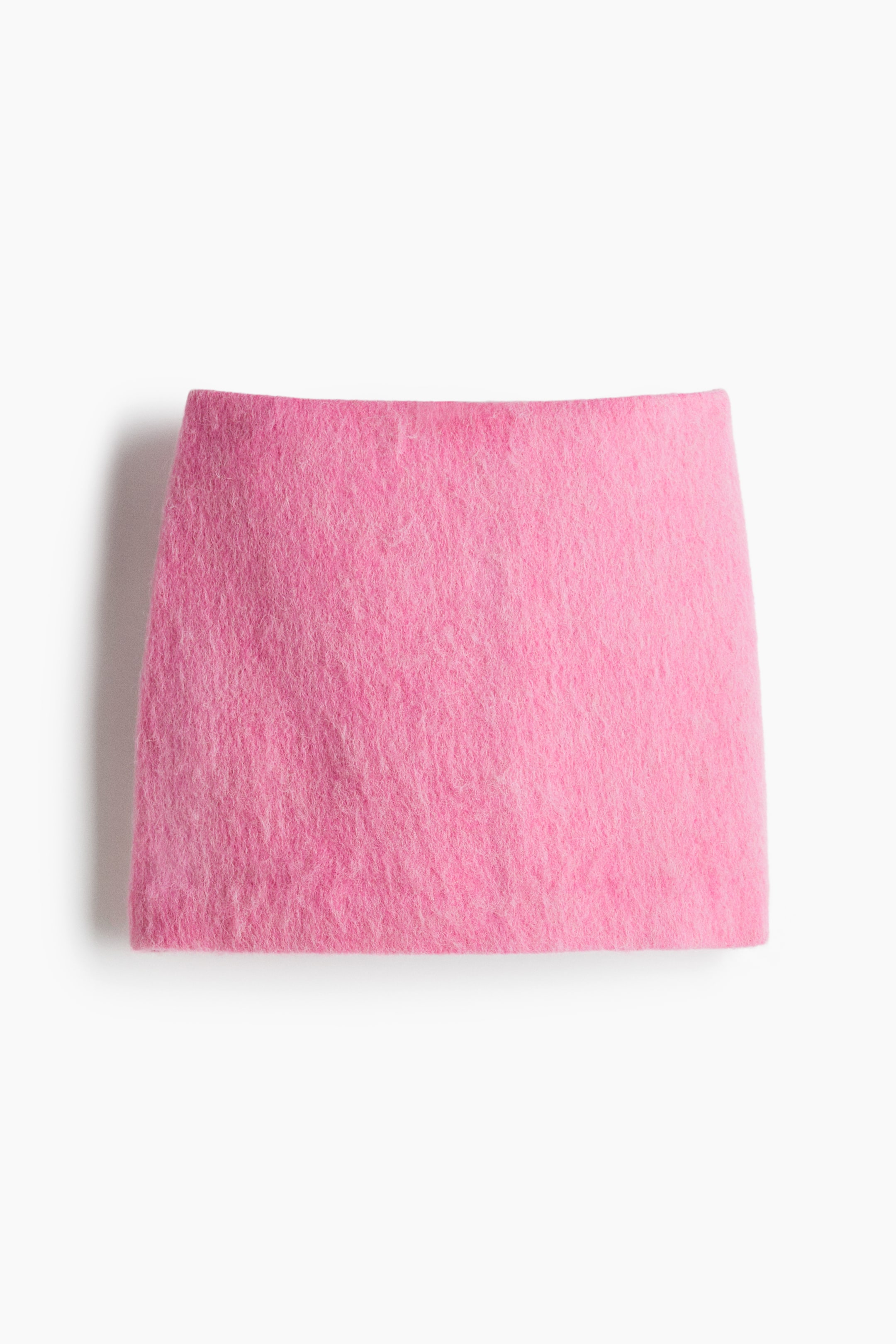 View larger image: A vibrant pink skirt is presented flat, featuring a short, straight cut and a soft, fuzzy texture. Its top edge is gently curving, while the side and bottom edges are straight.