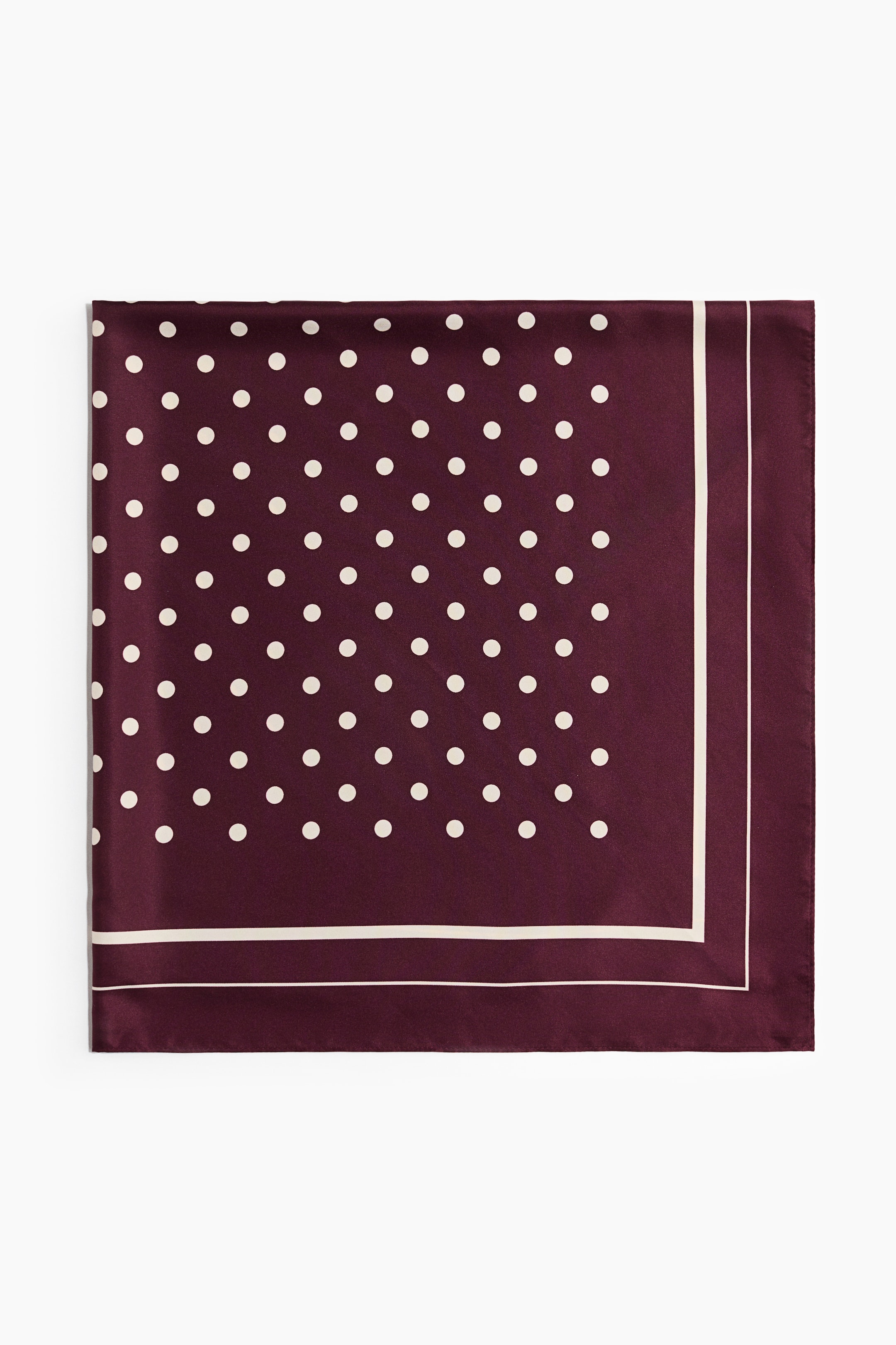 View larger image: A square scarf in a soft weave is laid flat, showcasing its front design in a deep burgundy color. It features a printed pattern of white polka dots in the center, bordered by a solid burgundy frame with two thin white stripes.