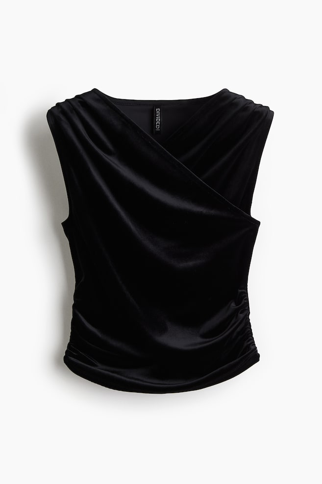 A black velour vest top is presented FRONT, showcasing a fitted style with a V-neckline and a sewn-in wrapover front creating a gently draped effect. Gathered seams are visible at the shoulders and along the side seams towards the hem, forming ruched details. - 1