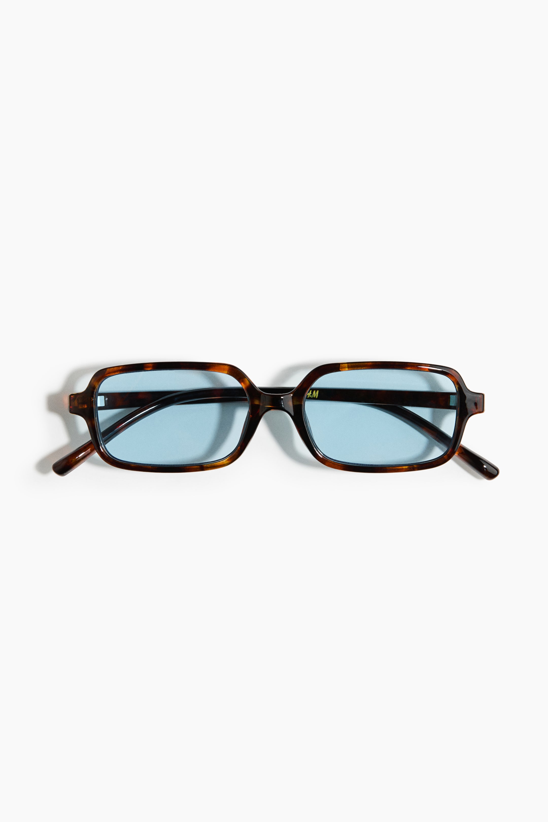 View larger image: Rectangular sunglasses feature tortoiseshell plastic frames and sidepieces. Blue-tinted plastic lenses complete the front view of the product.