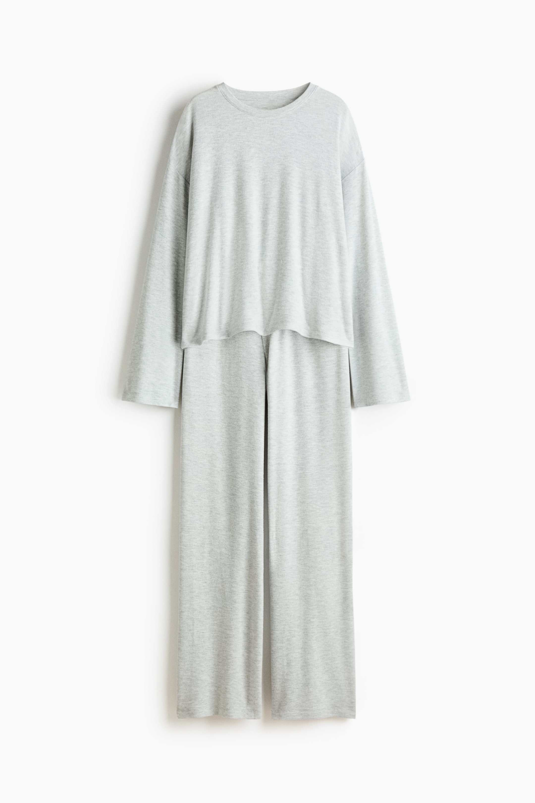 View larger image: A light gray two-piece loungewear set is displaying a front view, featuring a long-sleeved, crew neck top with a relaxed fit and straight hem. The top is layering over matching full-length, wide-leg pants that are presenting a relaxed, straight cut.