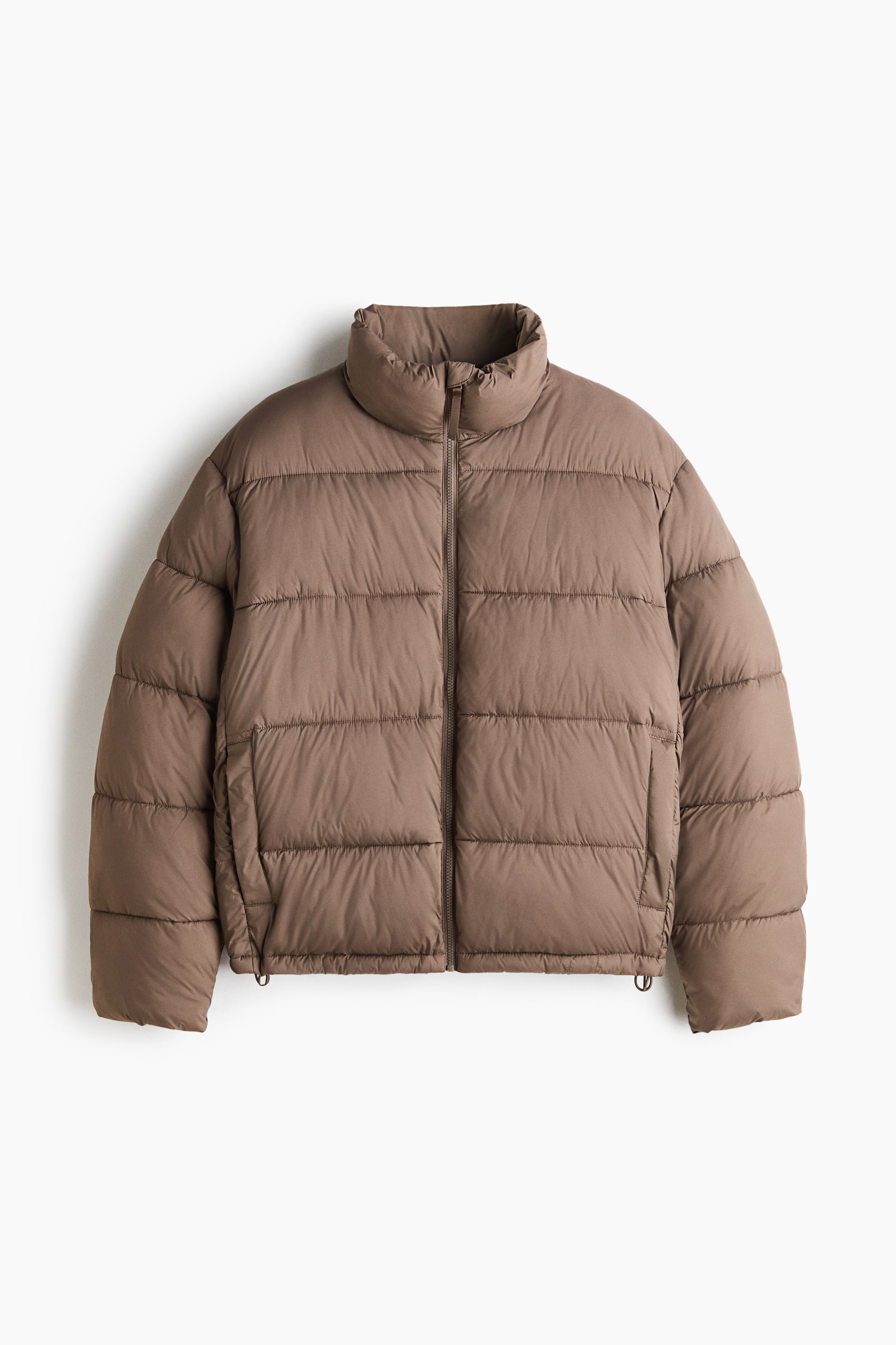 View larger image: A taupe-brown puffer jacket is shown from a front-facing view, featuring horizontal quilting, a high stand collar, and a full-length front zipper. The jacket is designed with long sleeves, elasticated cuffs, side welt pockets, and a drawstring hem.