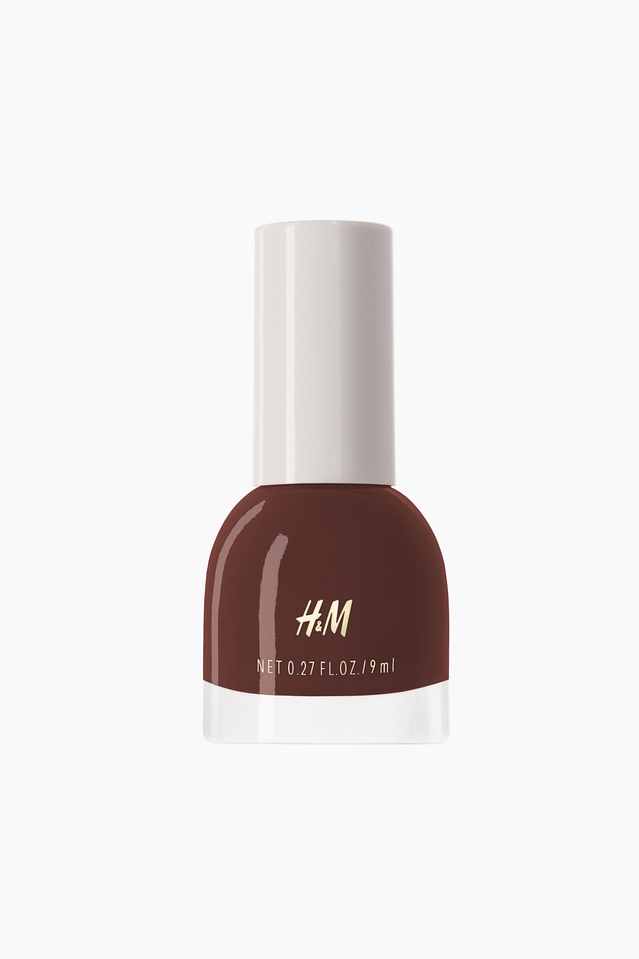 View larger image: The nail polish bottle showcases a deep reddish-brown shade, characterized by a transparent glass base, a rounded body, and a white cylindrical cap. The front of the bottle features the gold H&M logo and white text stating "NET 0.27 FL. OZ. / 9 ml".