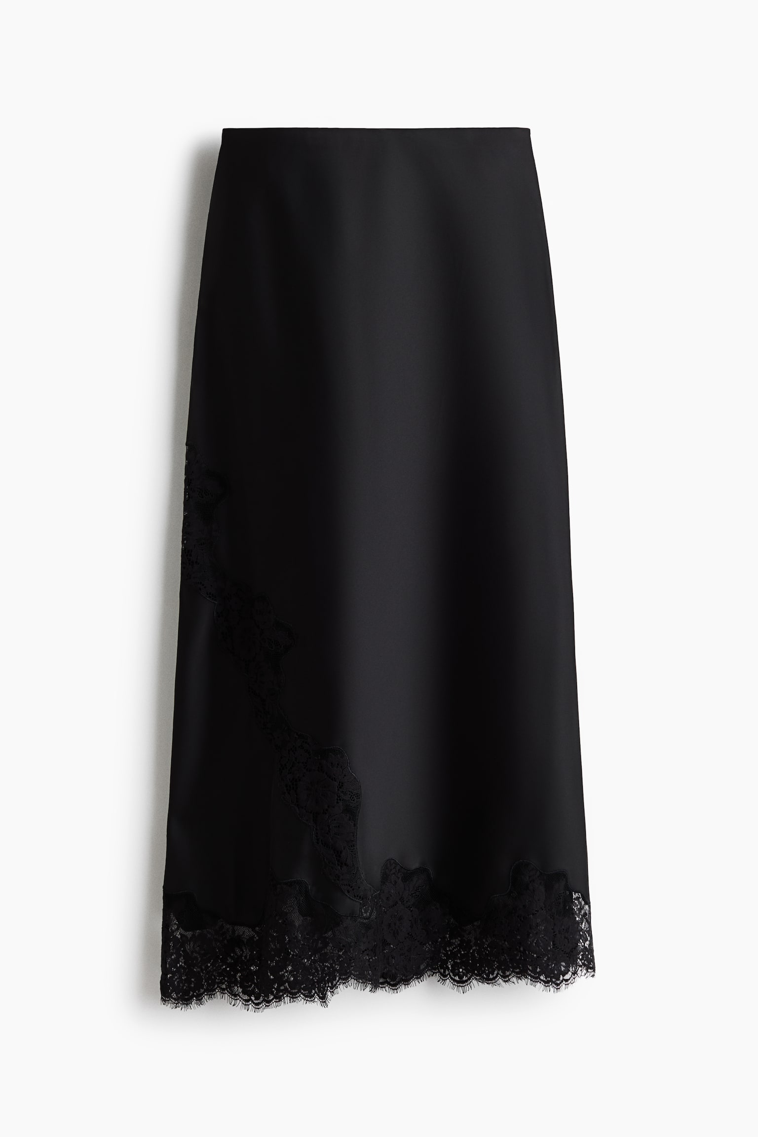Una falda midi de satén negro está colgada de frente, mostrando una caÃda suave y lustrosa. Presenta un inserto diagonal de encaje floral negro en la parte inferior izquierda que conecta con un dobladillo de encaje de pestañas con borde festoneado.