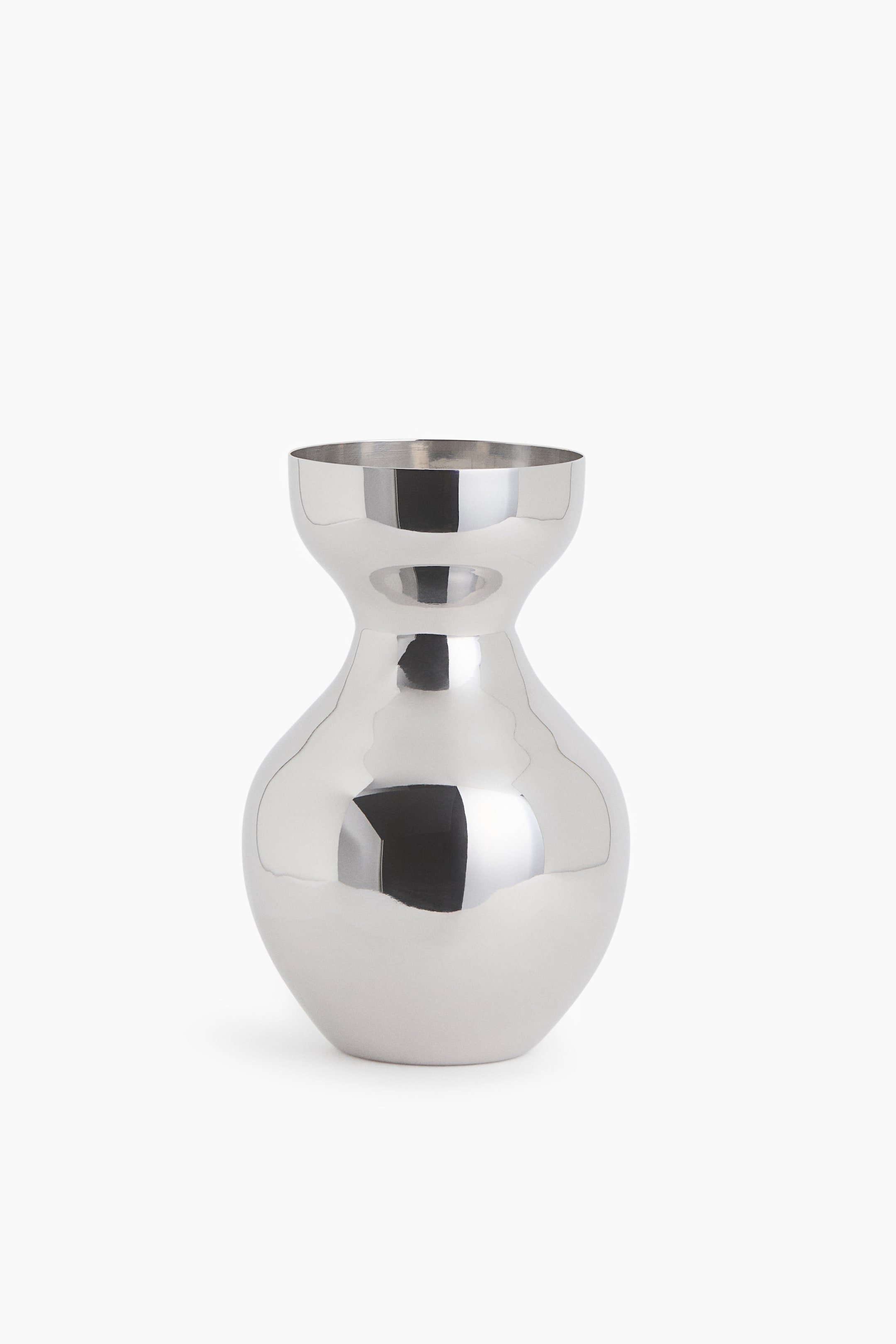 View larger image: A polished silver-toned metallic vase is standing upright in a front view, featuring a bulbous, rounded body that tapers into a narrow neck and flares into a wide, cup-like rim. The highly reflective chrome-like surface shows smooth, distorted reflections of light and dark shadows.