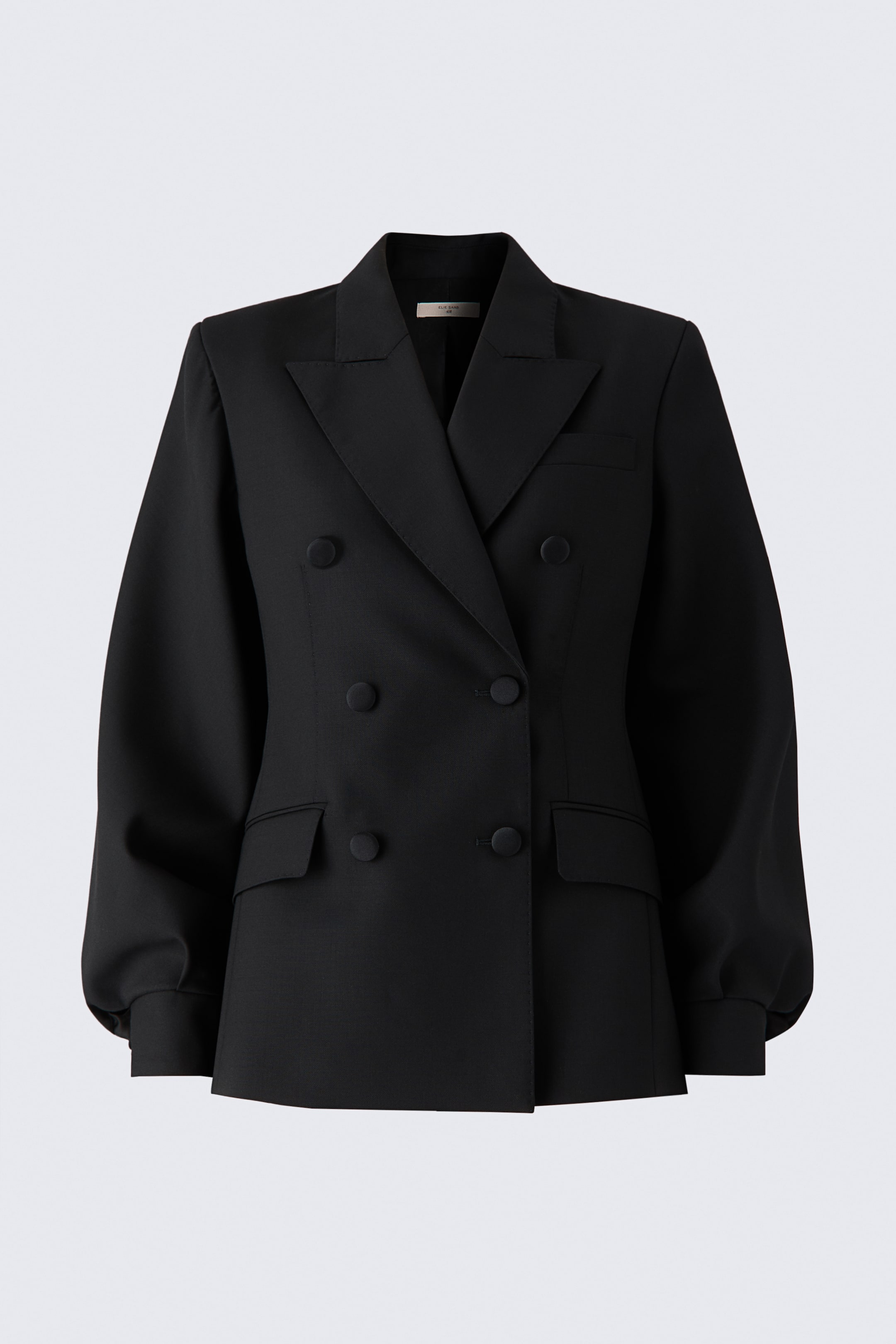View larger image: A black double-breasted wool blazer is shown from the front, featuring structured shoulders, sharp peak lapels, and a six-button front closure. The garment features voluminous, gathered sleeves with wide cuffs and two classic flap pockets at the hips.