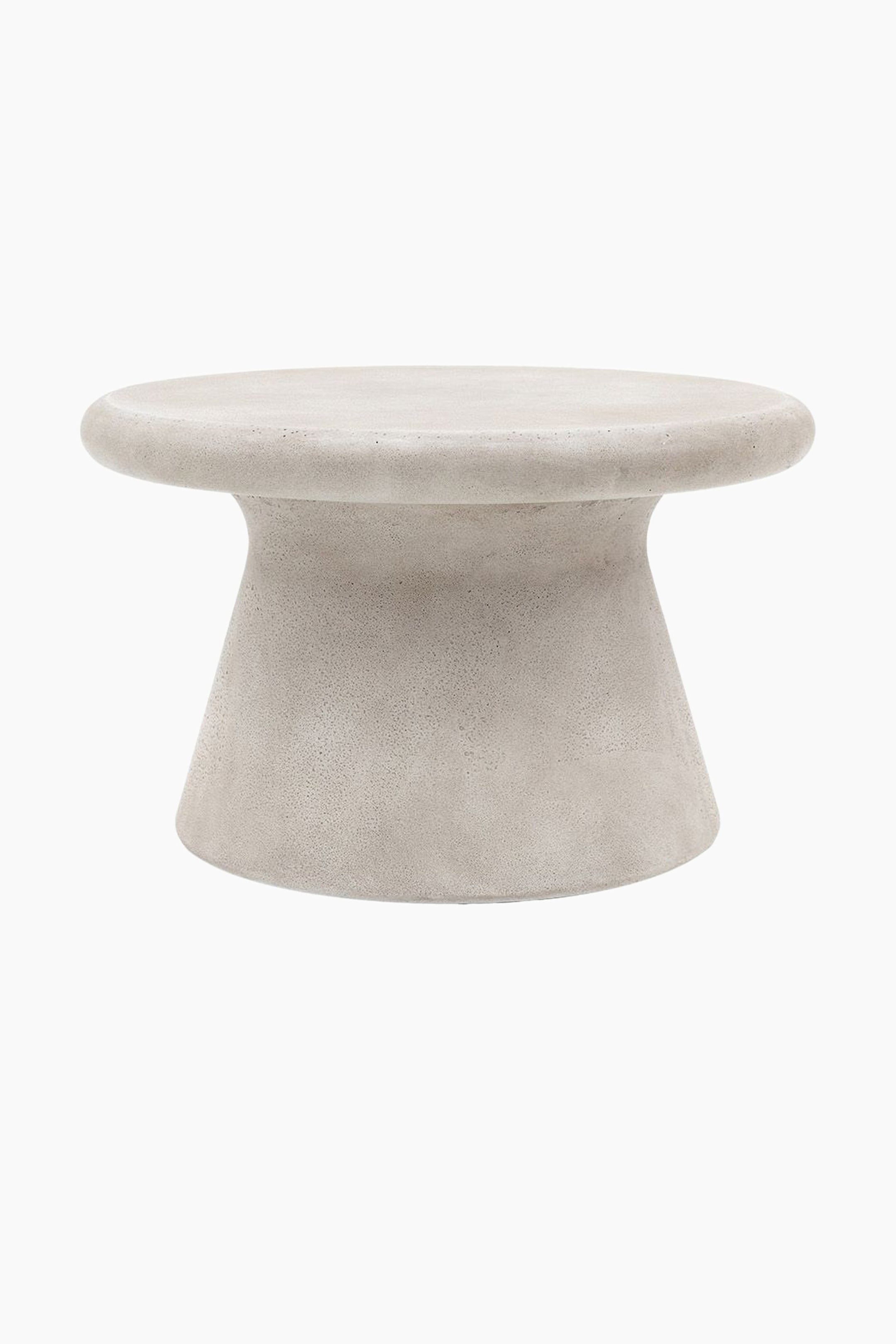 View larger image: A light grey concrete table presents a thick, rounded circular top and a flaring base. The base is narrower at the top and widens towards the bottom, and the entire surface features a textured, matte finish.