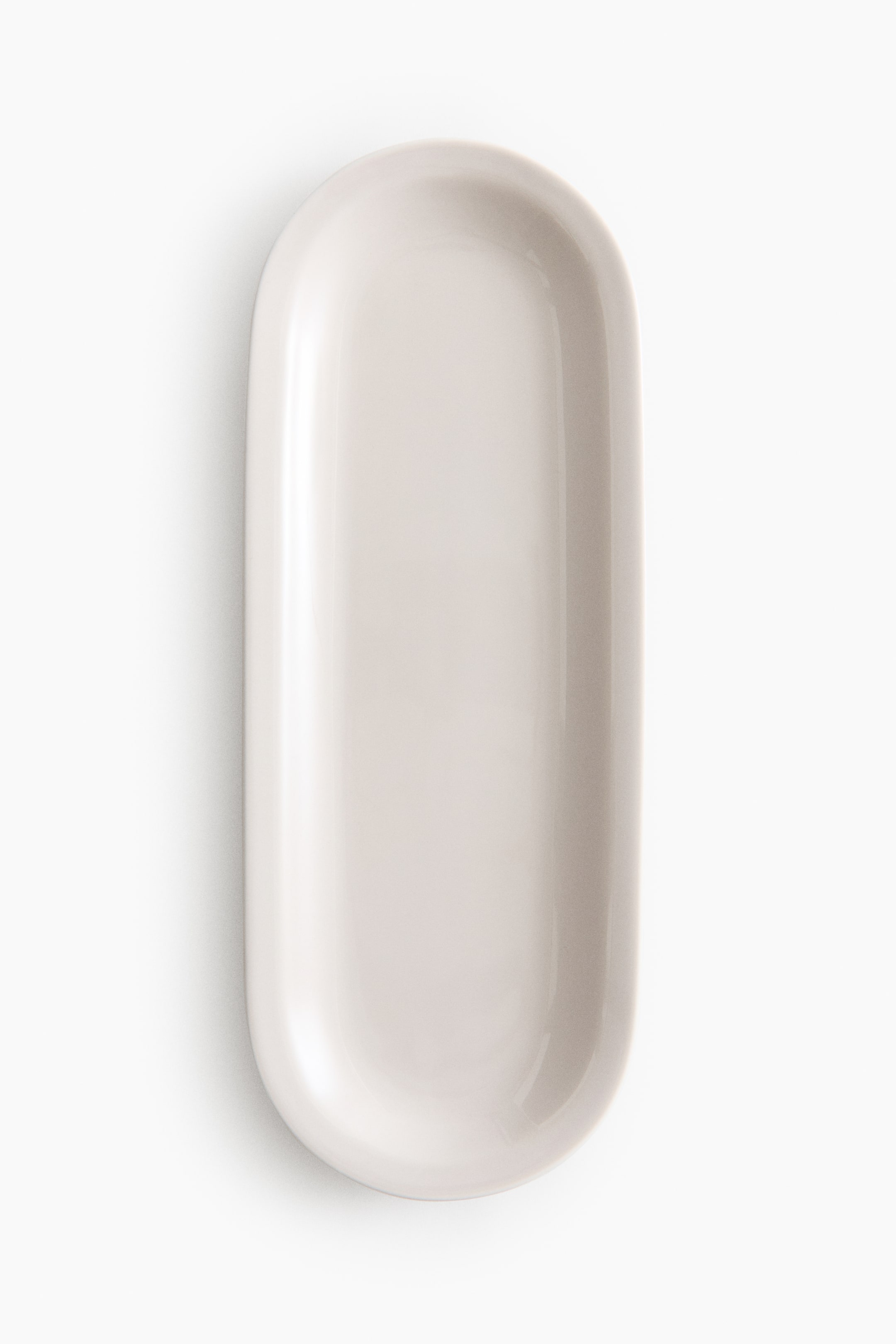View larger image: A rectangular, shallow tray showcases its light beige, smooth, and glossy surface. It features gently rounded ends and a continuous raised edge.