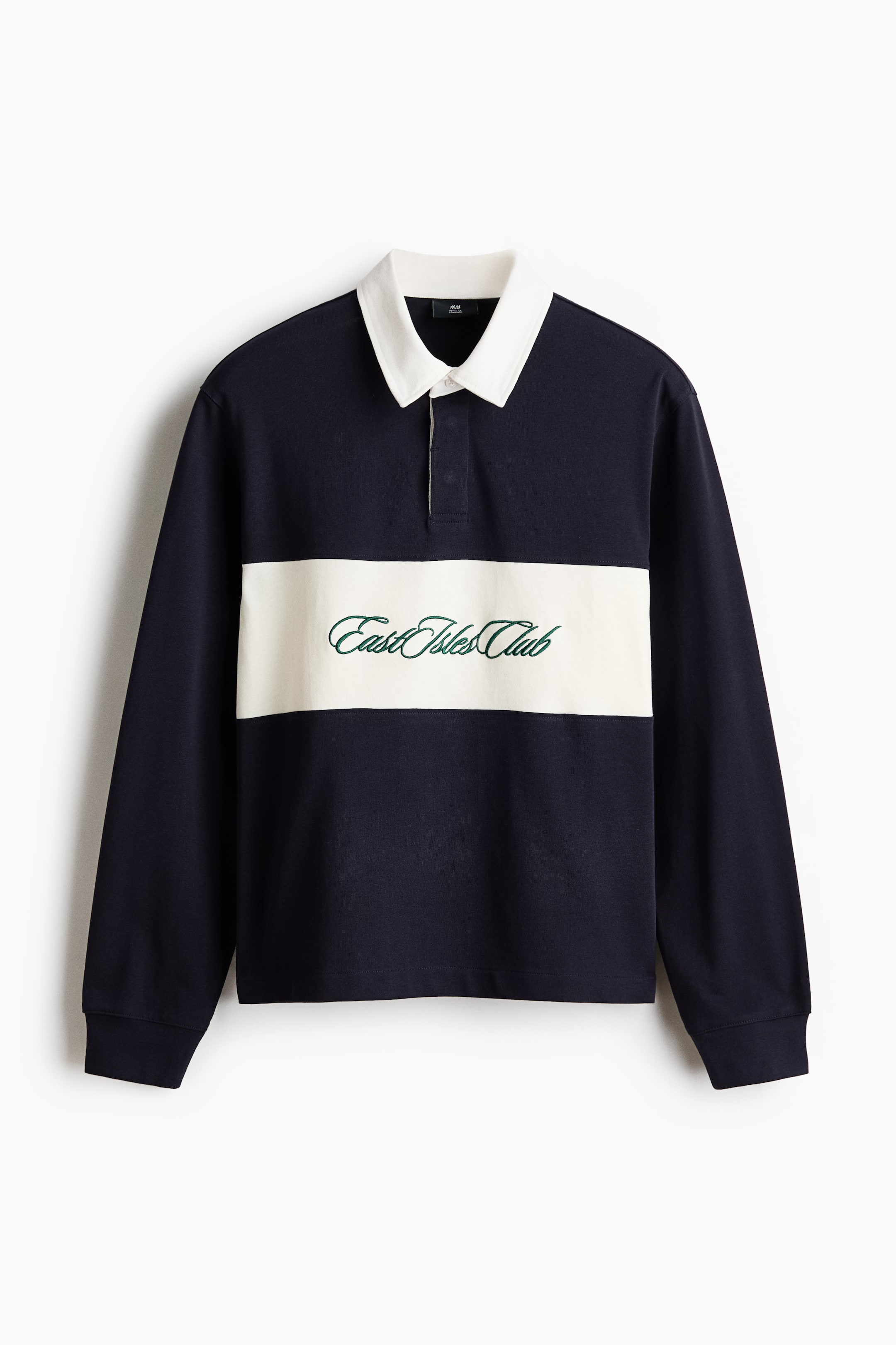 View larger image: A long-sleeved rugby shirt featuring a navy blue body with a horizontal cream stripe across the chest, shown from the front. It is designed with a white collar, a two-button placket, and ribbed cuffs. Green embroidered text reading 'East Isles Club' appears on the cream stripe.