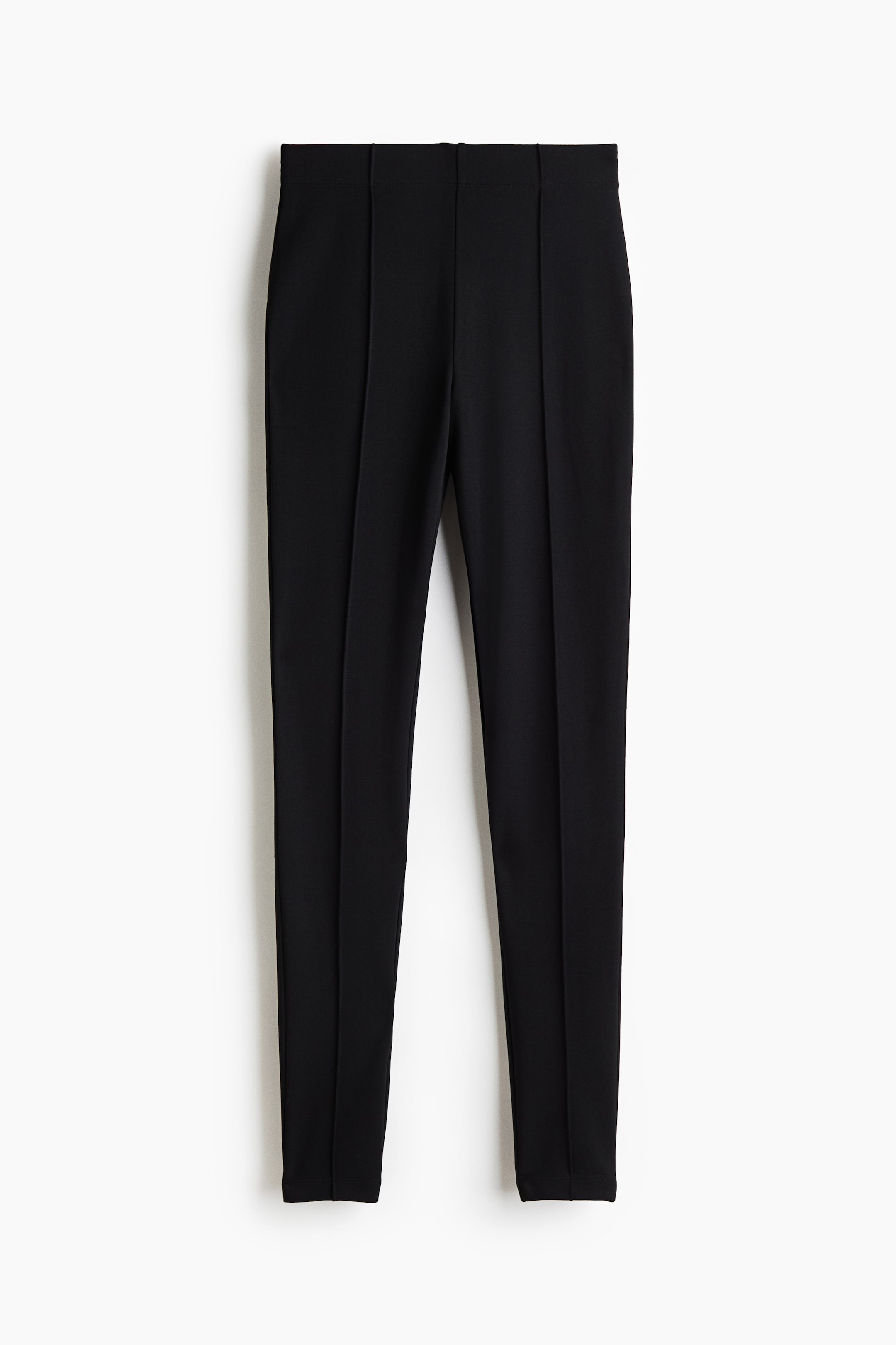 View larger image: A pair of black Ponte di Roma jersey leggings is shown front-on, featuring a high, elasticated waistband and sewn-in creases running vertically down the centre of each leg.