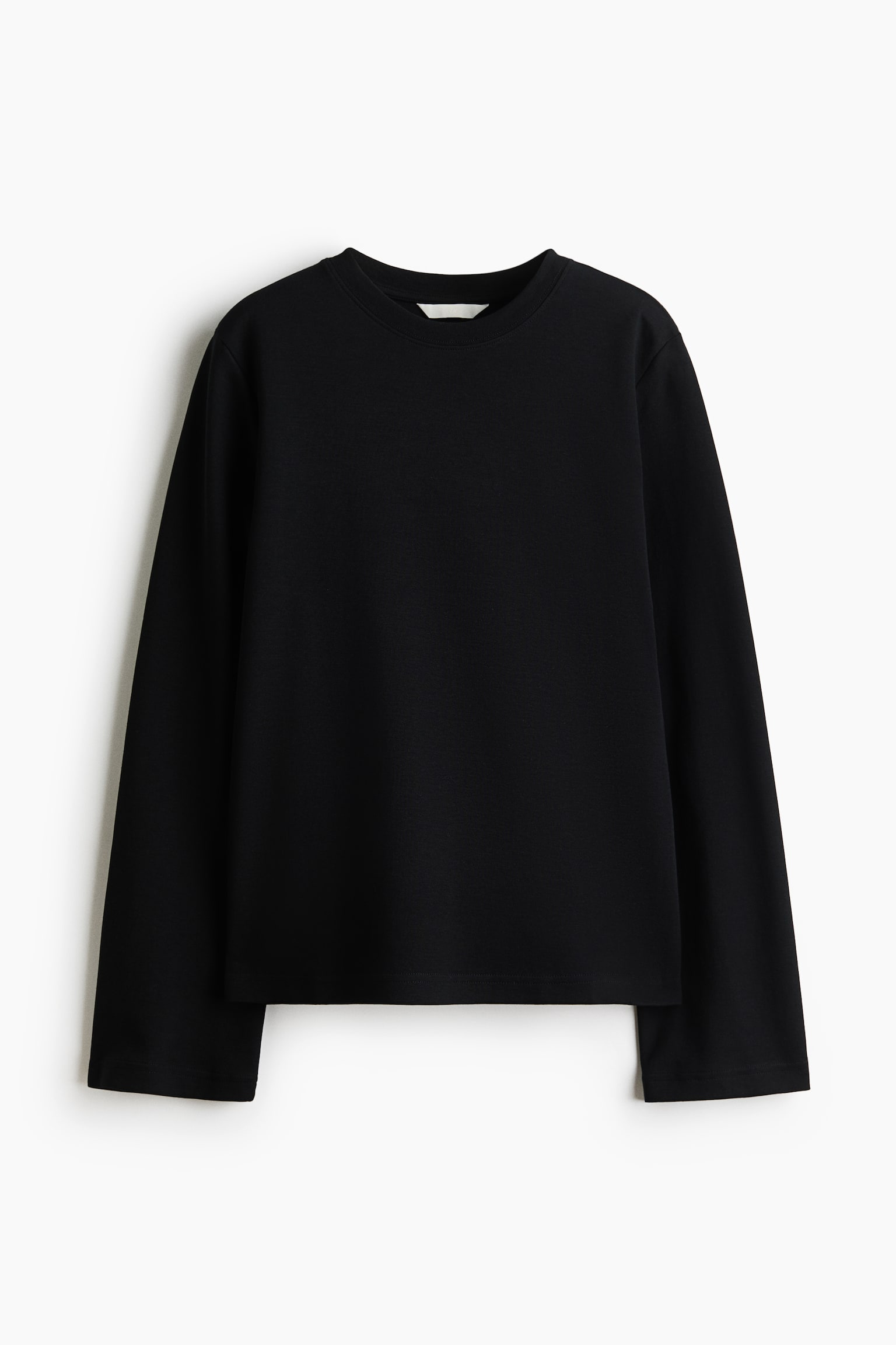 A black loose-fit top in a heavyweight interlock jersey is shown from the front, featuring a round rib-trimmed neckline, dropped shoulders, and long, straight-cut sleeves.