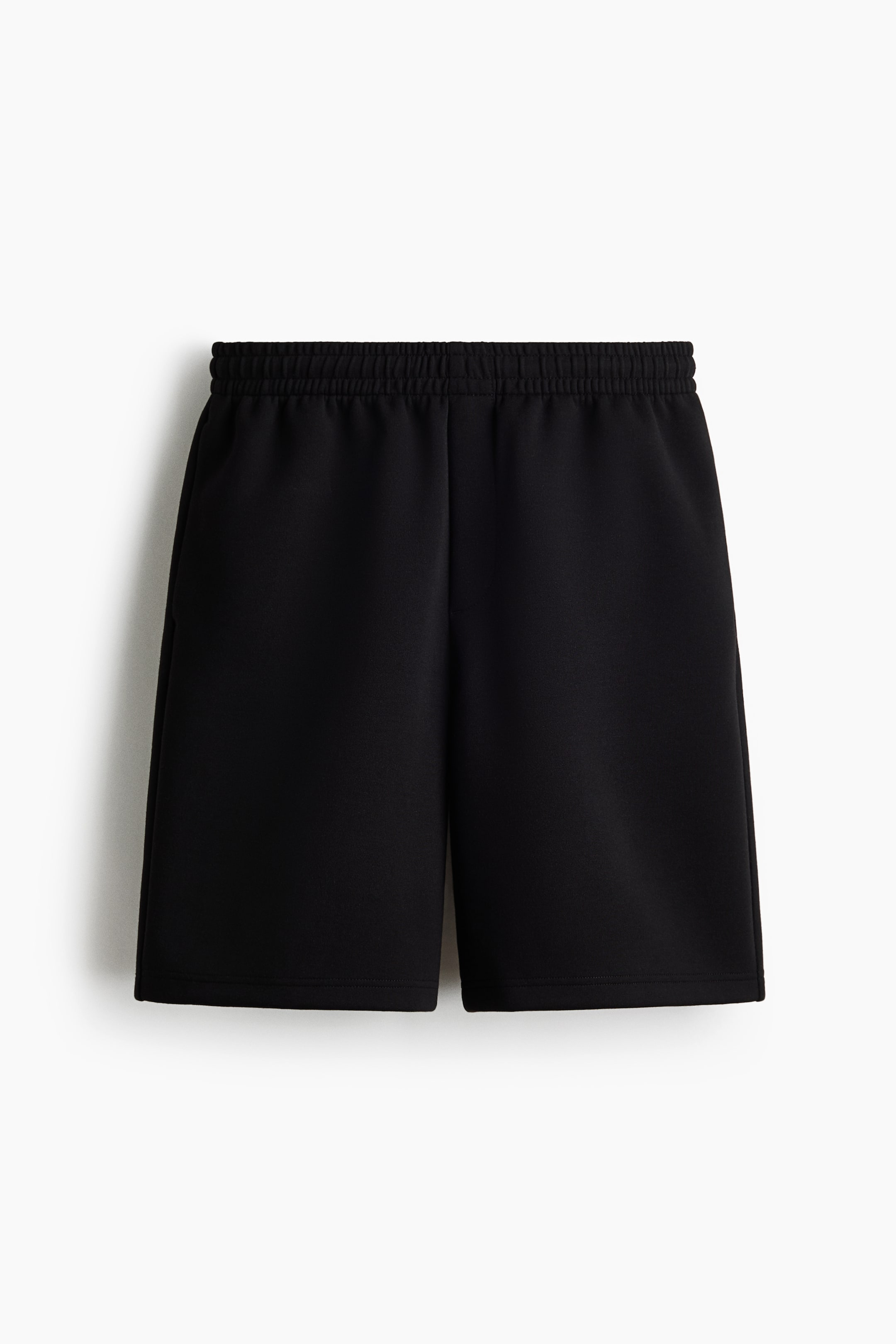 View larger image: Black shorts feature a gathered elastic waistband and a relaxed fit in a smooth fabric, presented from the front.