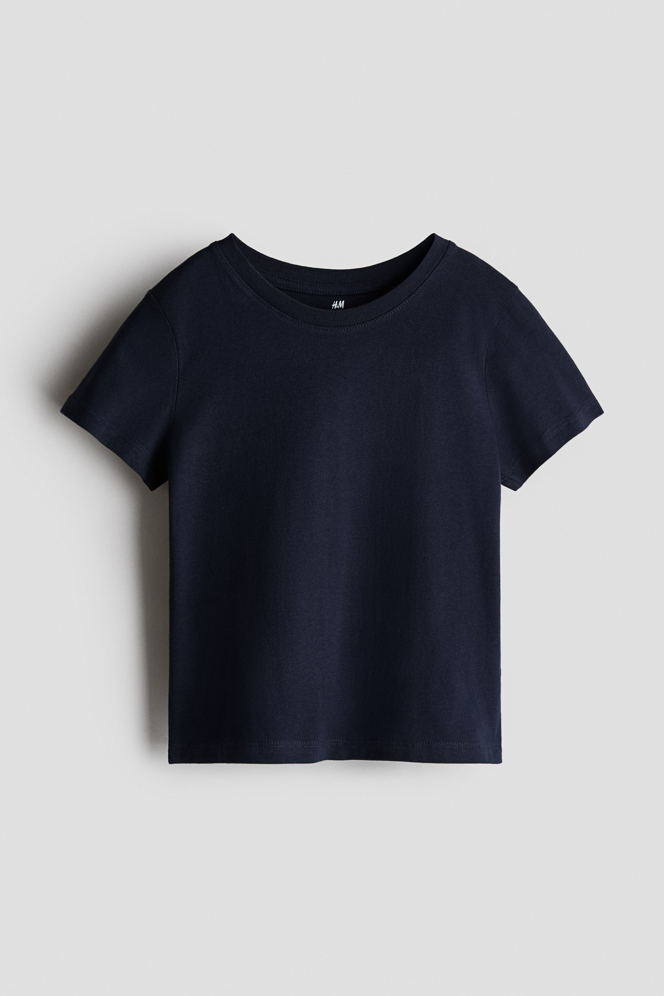 View larger image: T-shirt in soft cotton jersey. The FRONT of the dark blue t-shirt showcases a ribbed crew neck with a visible brand label, short sleeves, and a straight hem.