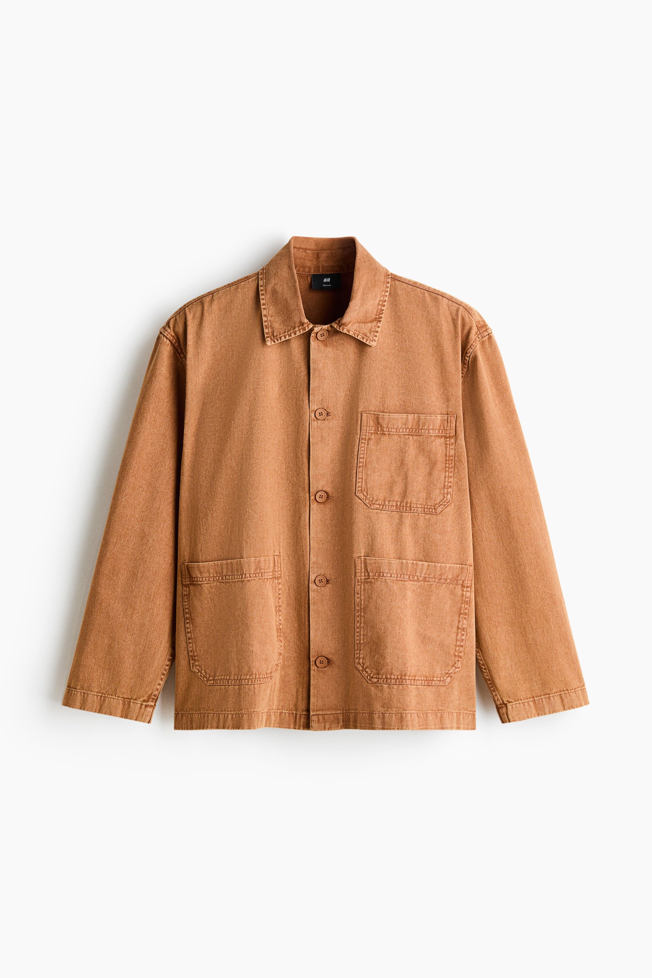 View larger image: A faded brown worker jacket is showcasing its front, featuring a pointed collar and a full button placket with five matching buttons. Four large patch pockets are visible on the front, two at the chest and two at the waist, all with visible topstitching.
