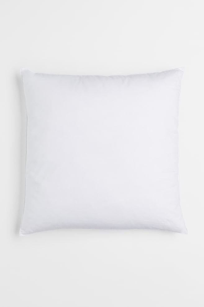 puffy, white pillows carpet AMO's shop-in-shop boutique for