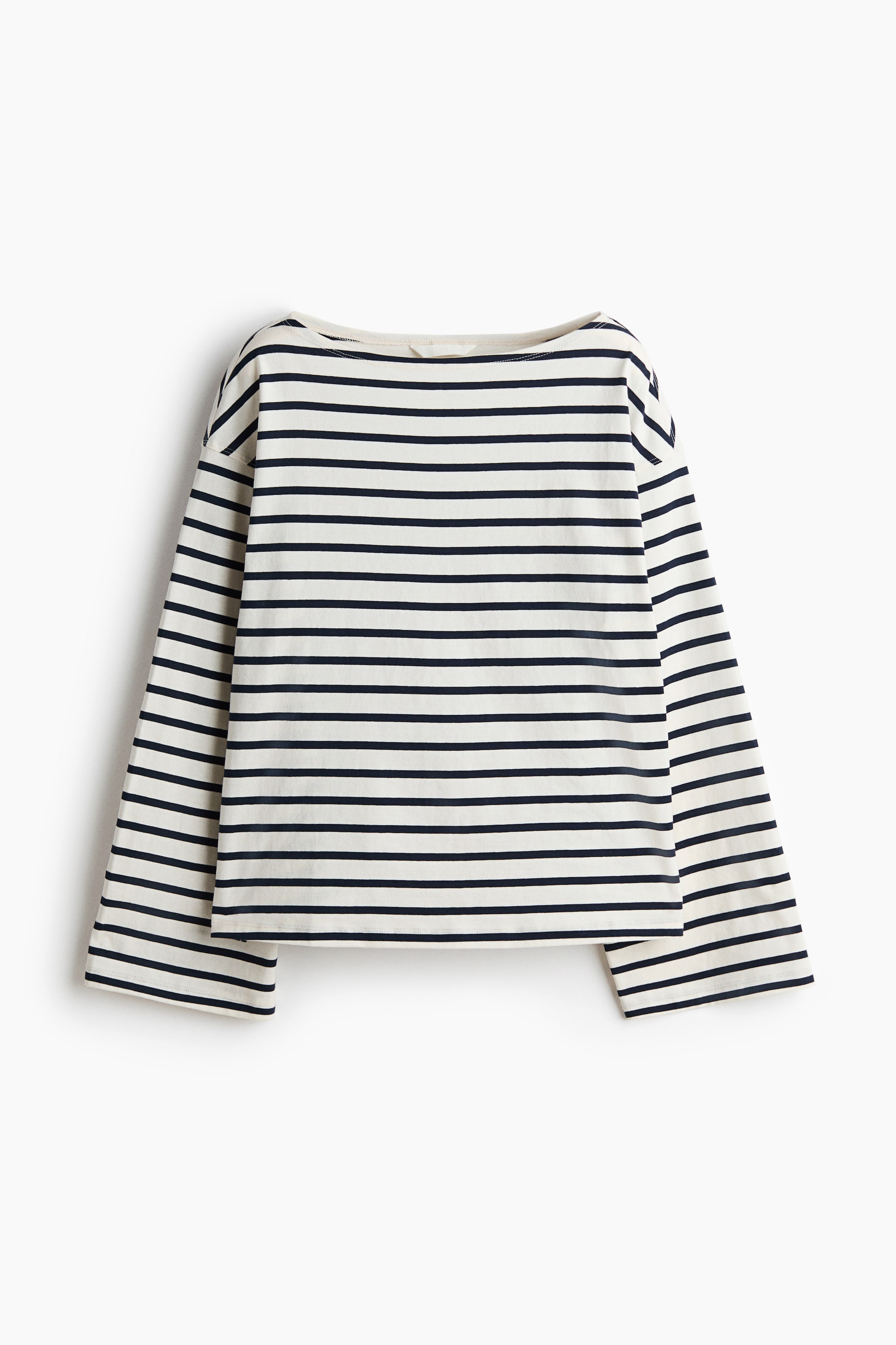 View larger image: The long-sleeve shirt is laid flat, showcasing a front view. It features cream and navy horizontal stripes, a boat neck, long sleeves, and a straight hem.