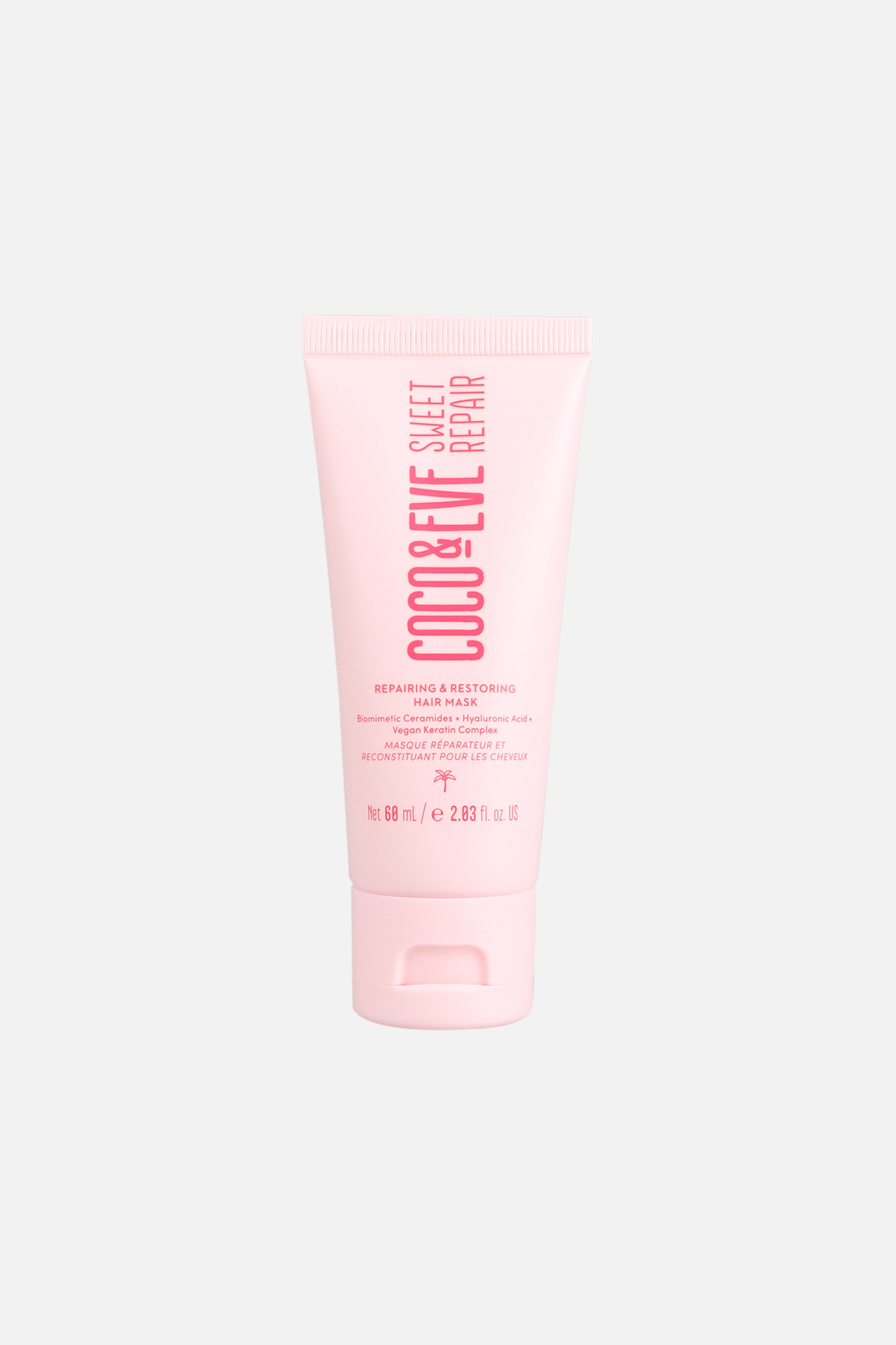 Visa större bild: En tub med Coco & Eve Sweet Repair Hair Mask står upprätt i frontvy och visar en ljusrosa klämförpackning med matchande flip-top-kork. Tubens framsida visar tydlig vertikal rosa text med ”COCO & EVE SWEET REPAIR” ovanför mindre tryckta produktdetaljer och en palmikon.