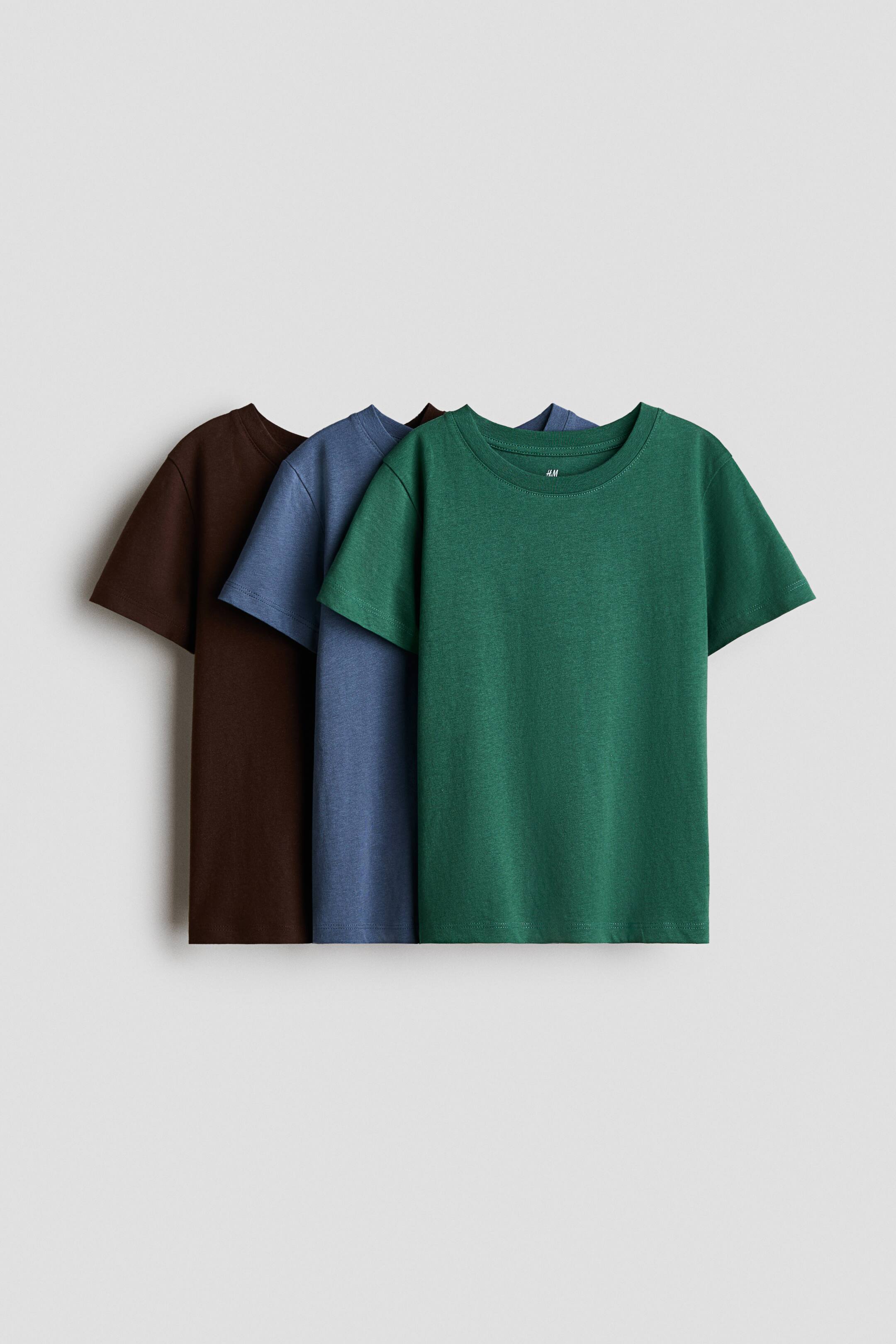 View larger image: Three plain short-sleeved T-shirts are presented, layered from right to left. The frontmost T-shirt is green, followed by a blue T-shirt, and then a brown T-shirt, each featuring a ribbed crew neck.